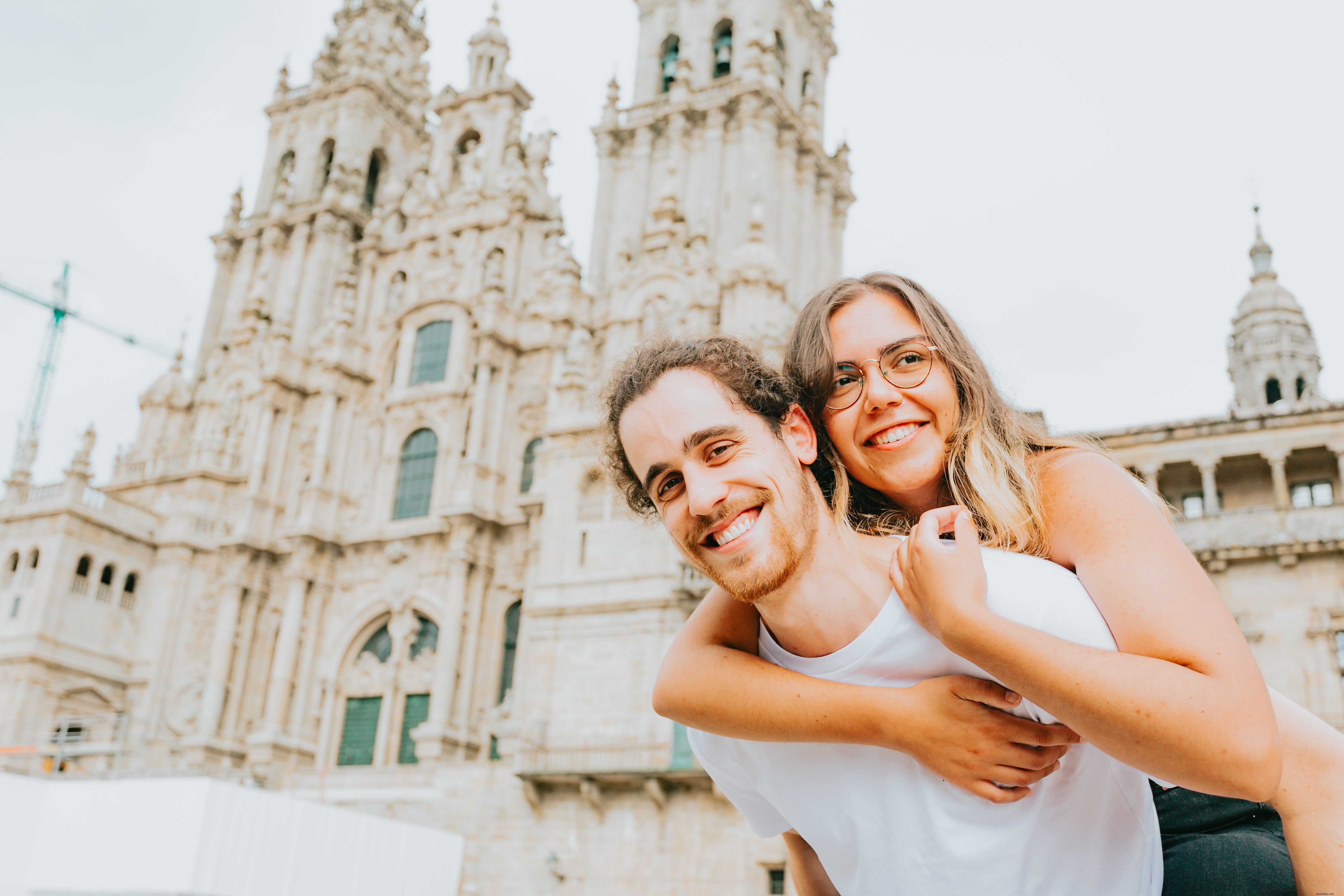 Joyful Piggyback Ride: Man Carries Smiling Woman in Heartwarming Photo