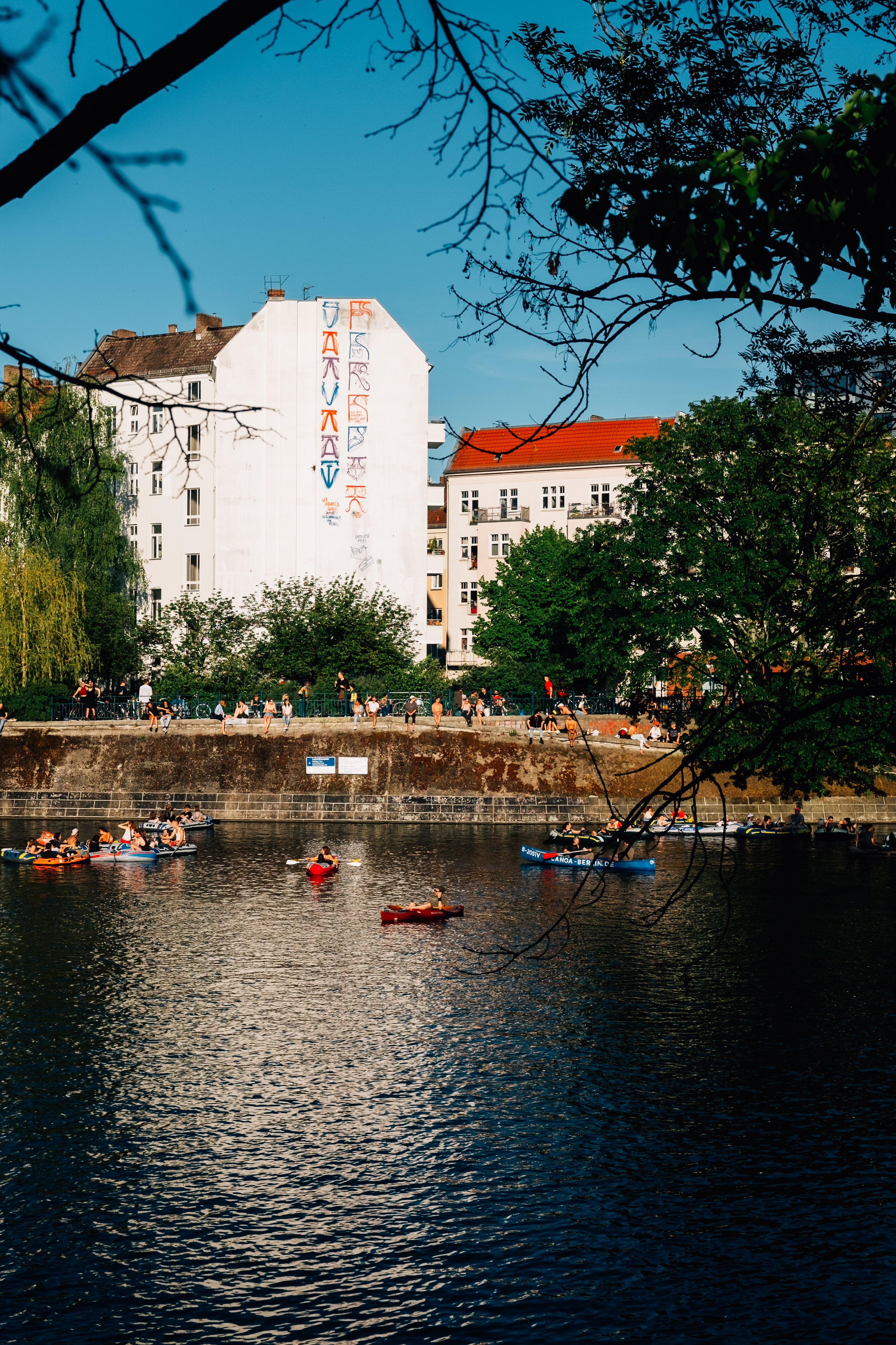 Kayaks Drifting on Urban River: Stunning City Skyline Photo