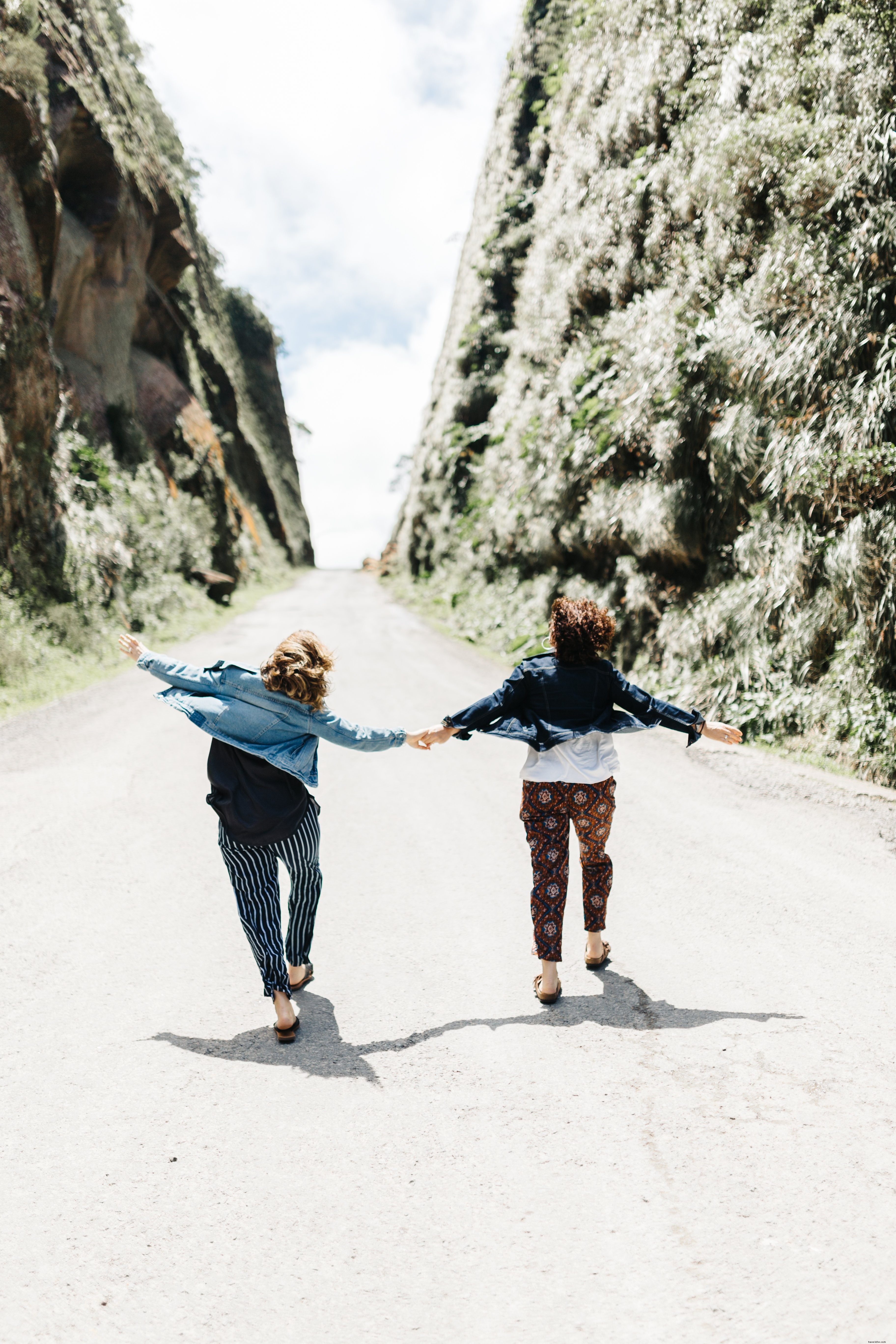 Romantic Couple Holding Hands Walking Up a Scenic Road – Stunning Photo