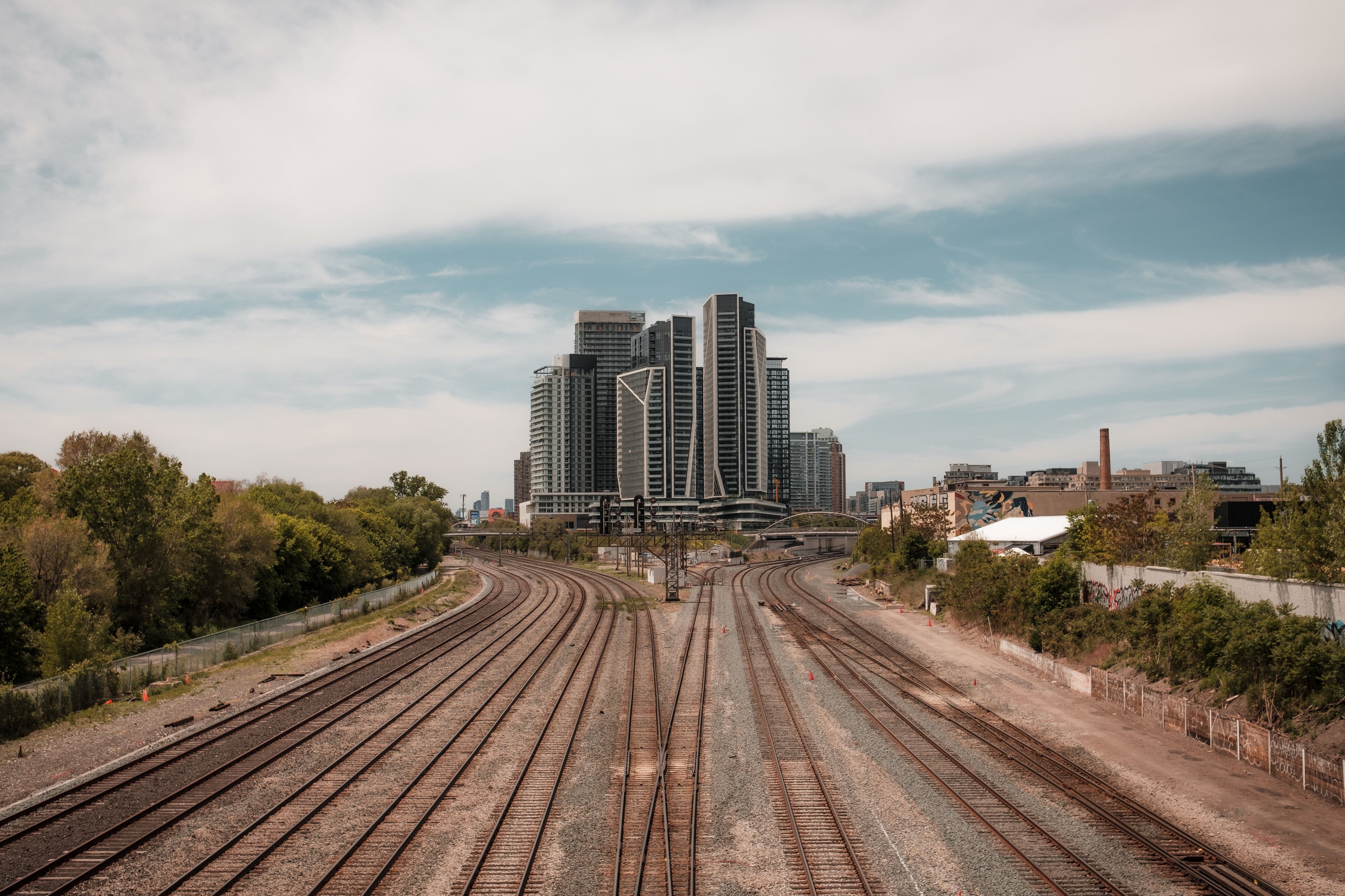 Stunning Photo: Train Tracks Diverging Amid Towering City Skyscrapers