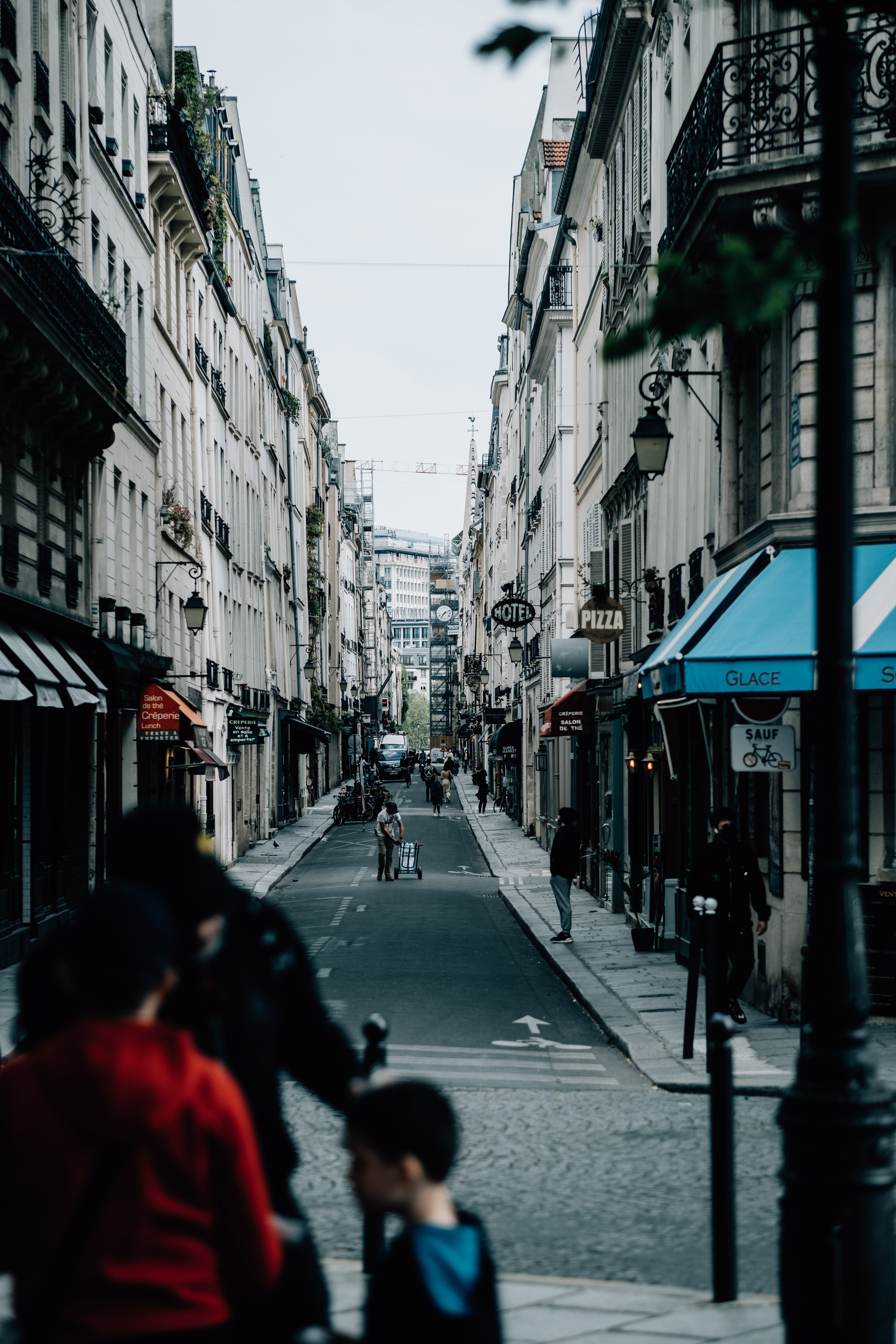 Stunning Narrow City Street Photo: Pedestrians Strolling Through Urban Heart