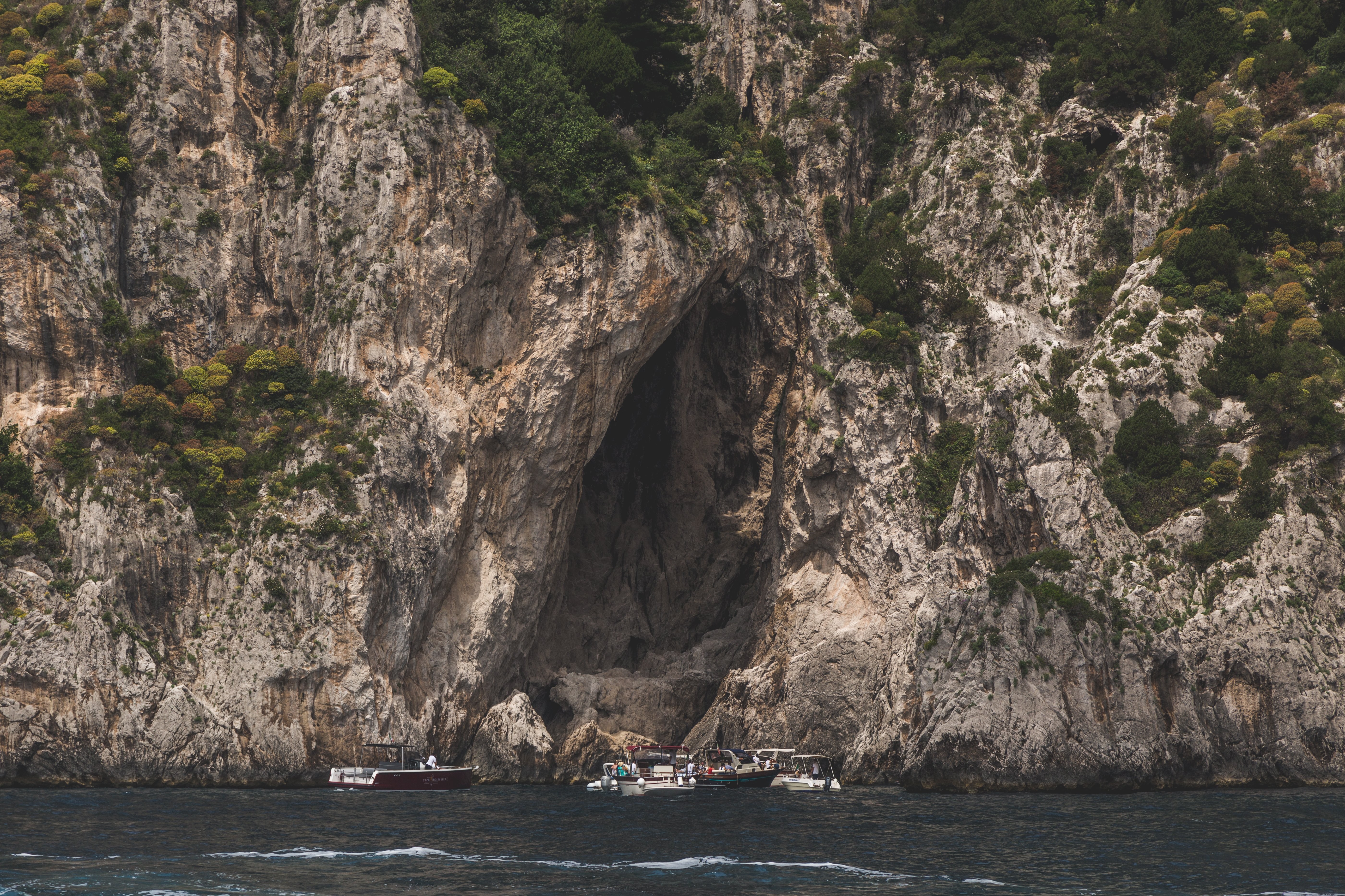 Stunning Cliffside Boats: Breathtaking Scenic Photo