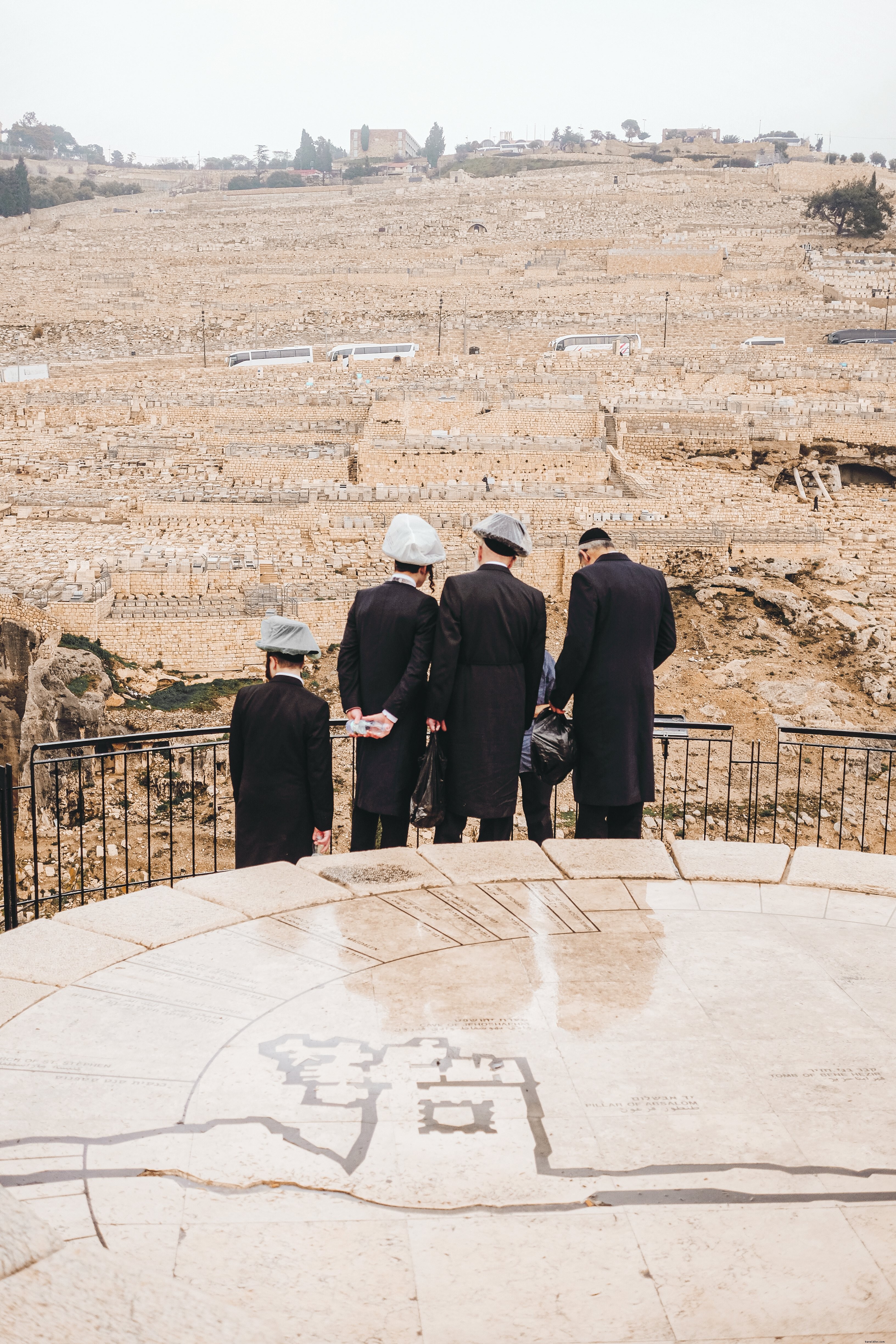 Captivating Photo: Four People Gazing Over Vast Stone Fields