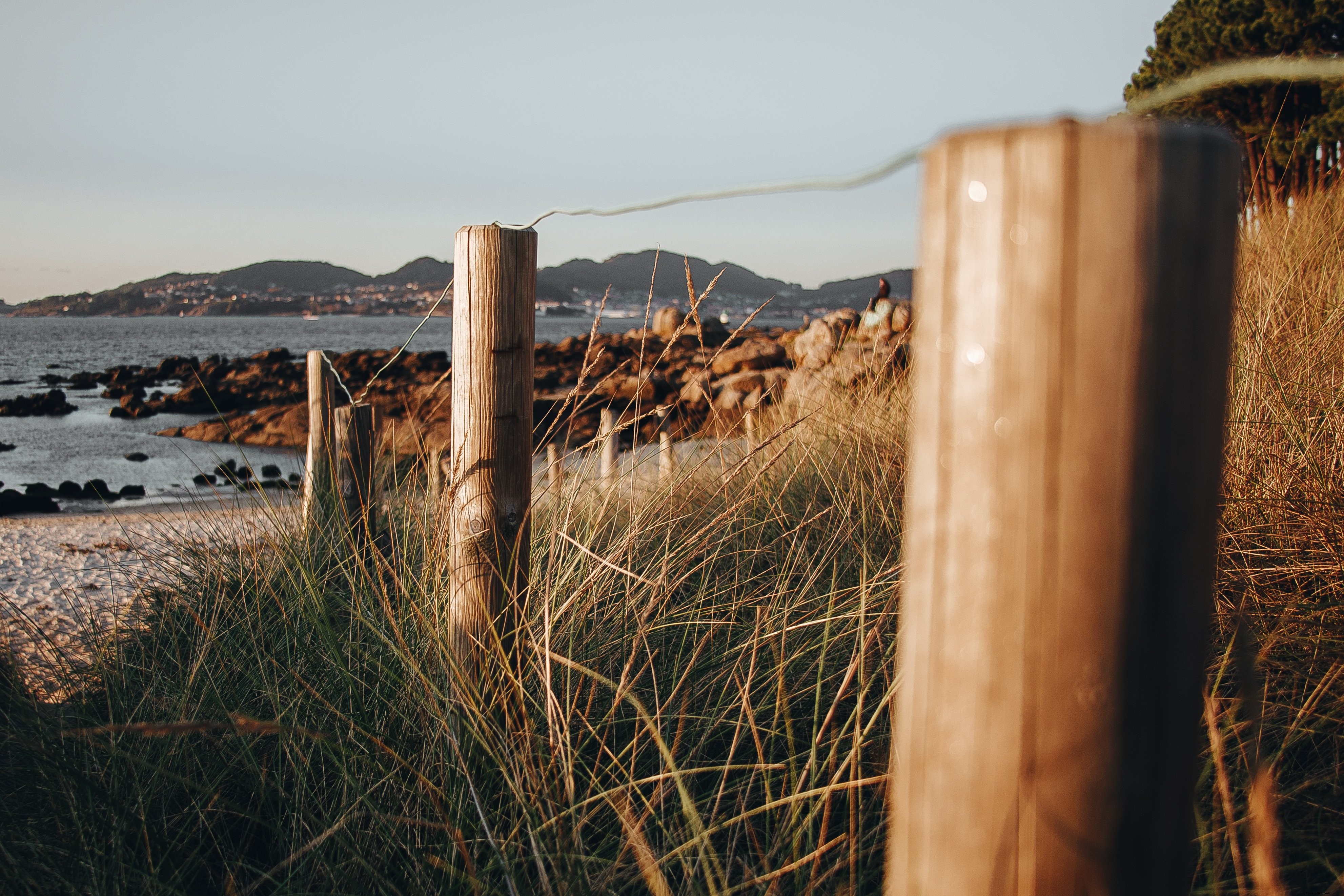 Journey Along the Fence Line to the Shore: A Stunning Landscape Photo