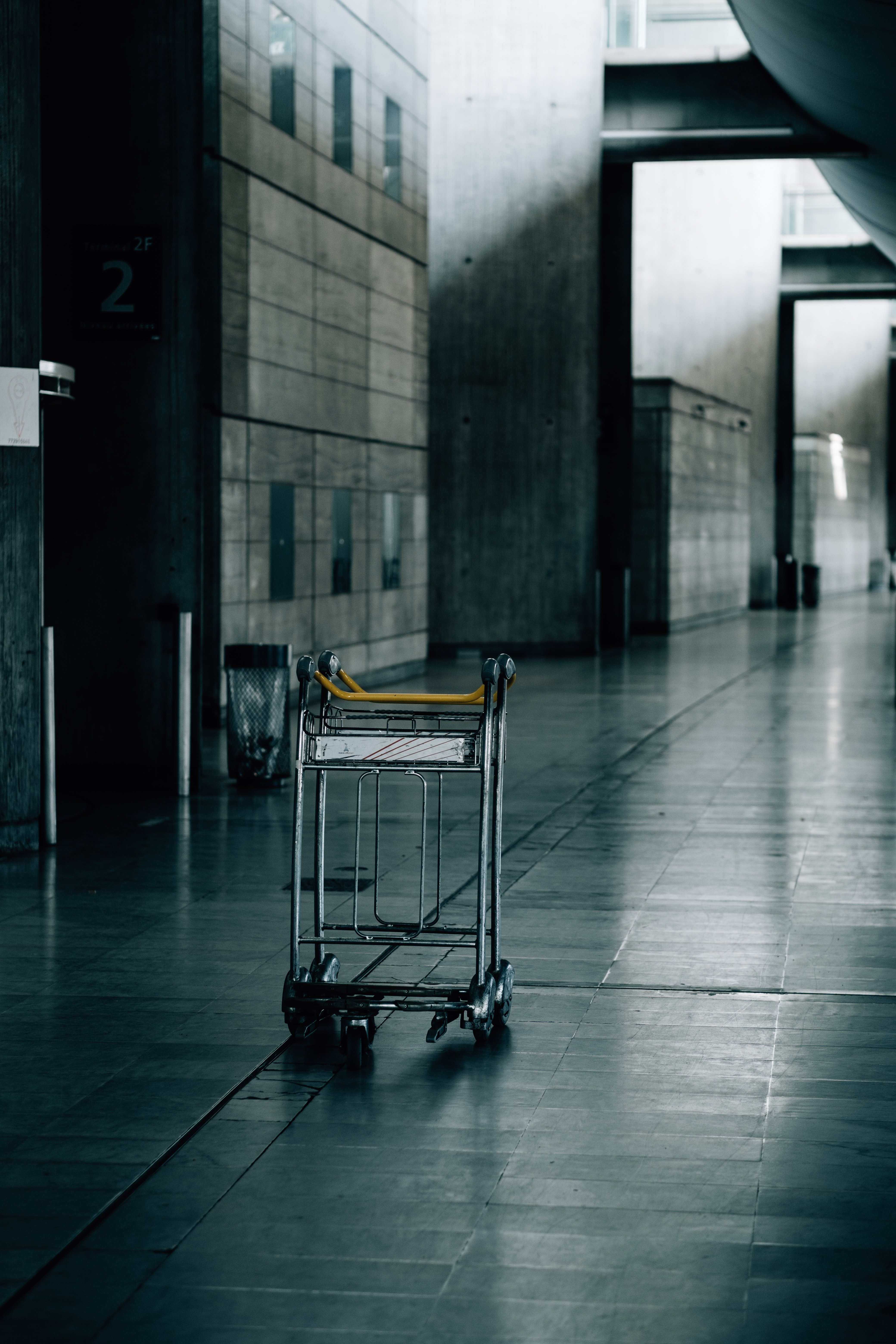 Empty Luggage Cart Captured in a Modern Industrial Corridor