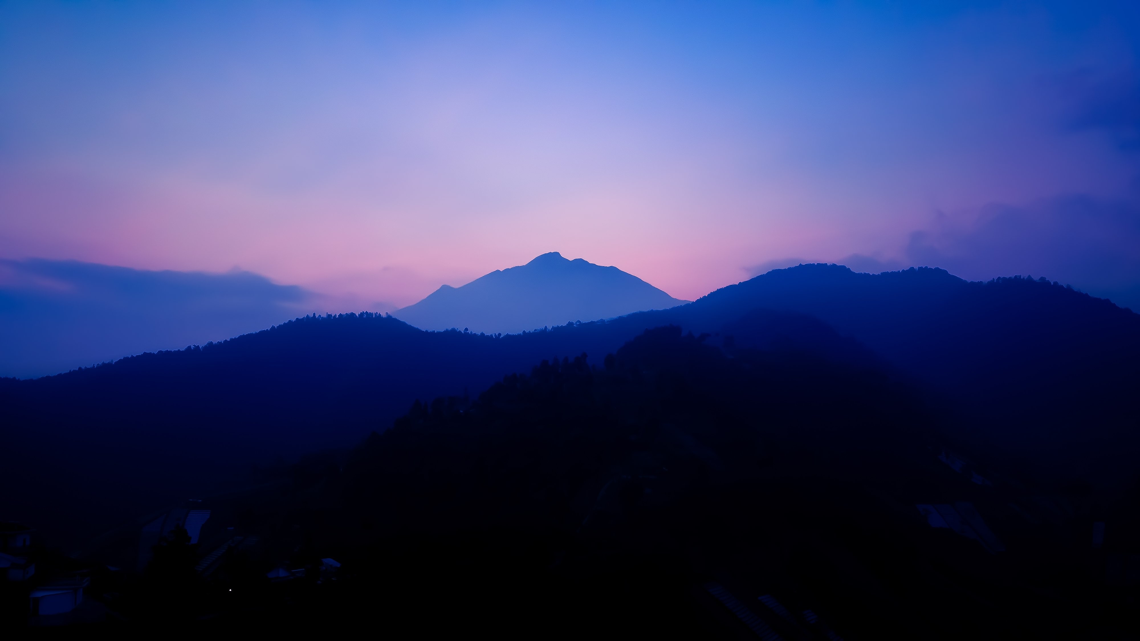 Stunning Sunset Landscape: Blue Hills and Pink Sky