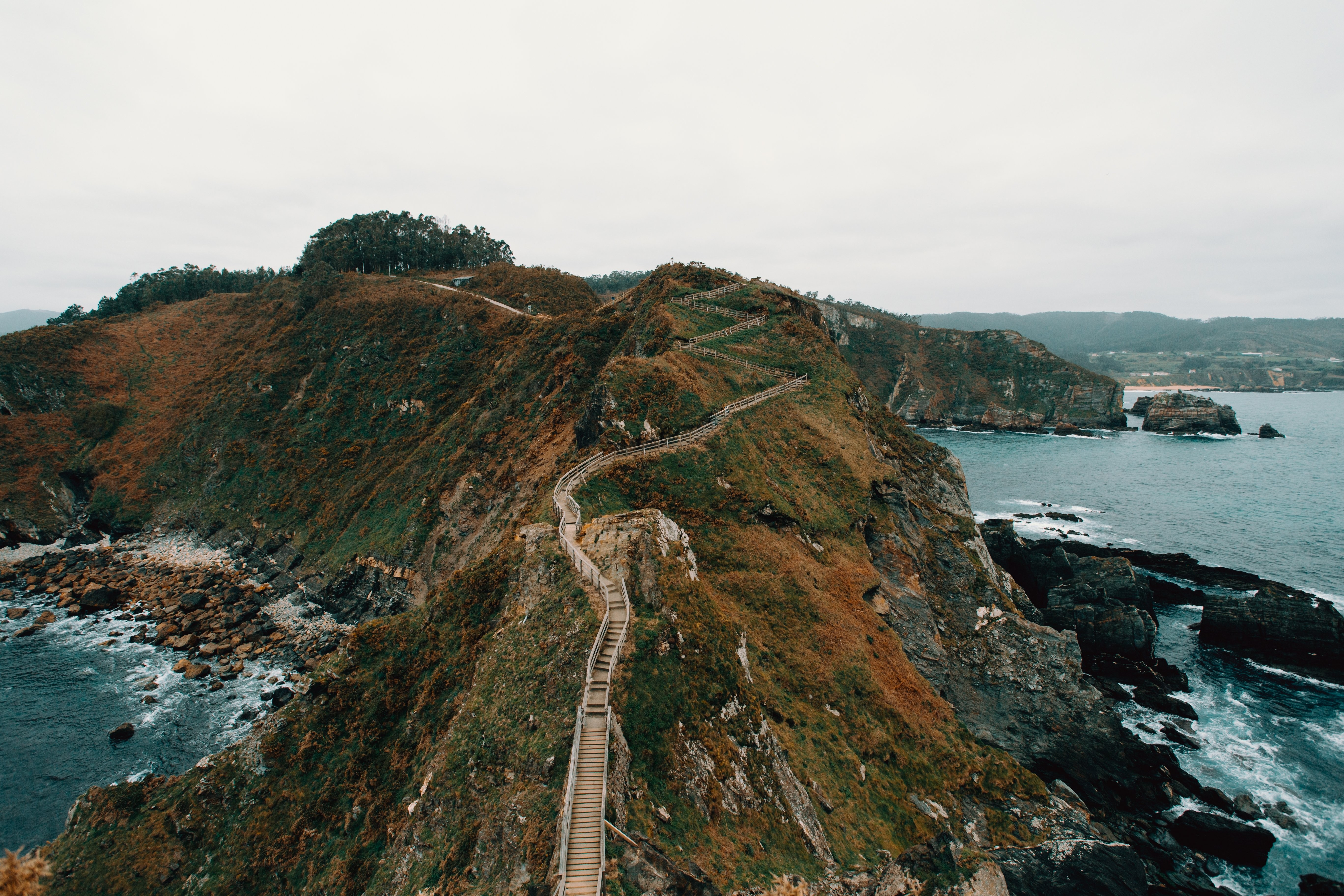 Stunning Aerial View of a Walkway Through Rocky Hills by the Water