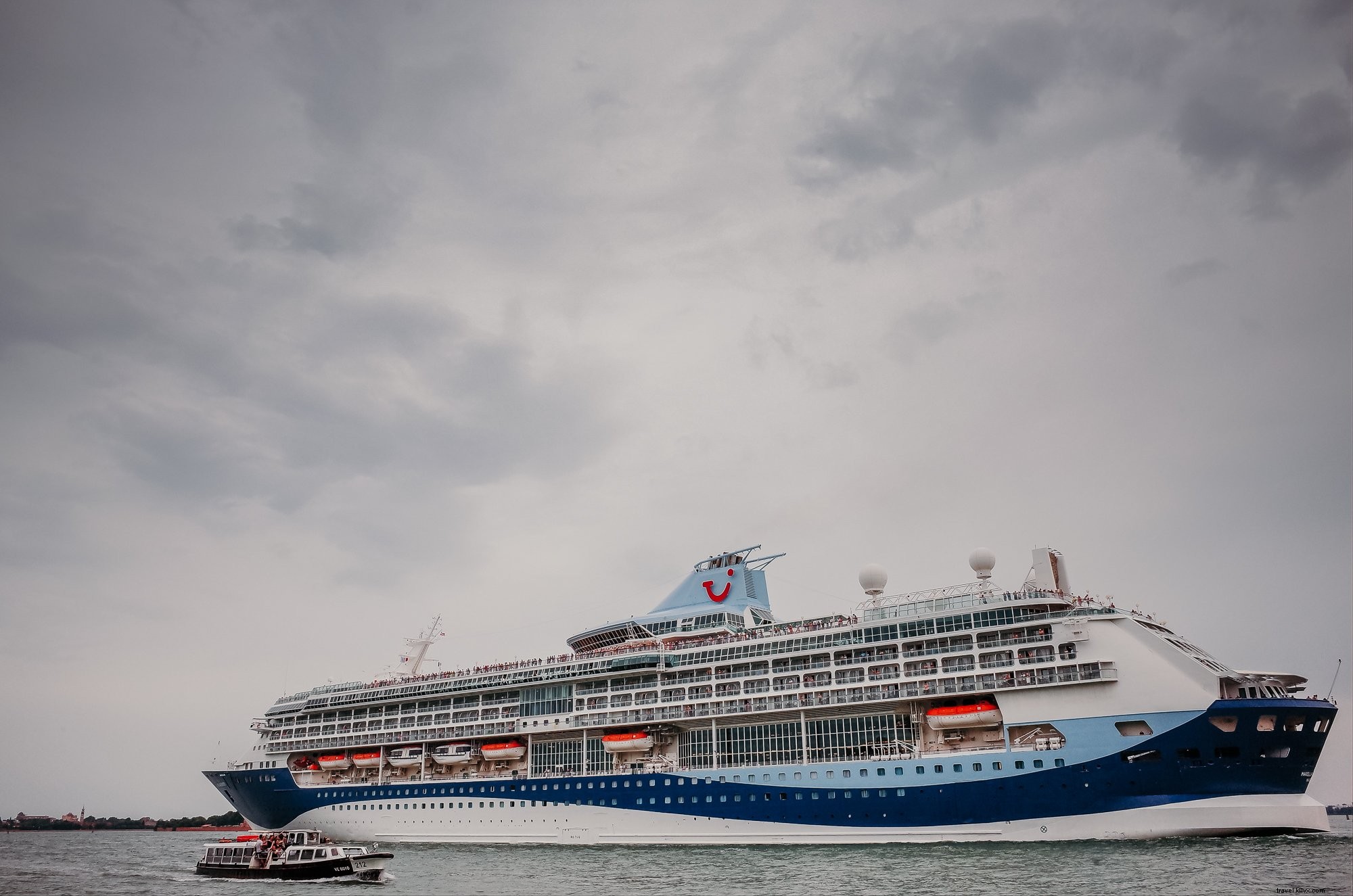 Stunning View of a Large White and Blue Cruise Ship on a Cloudy Day