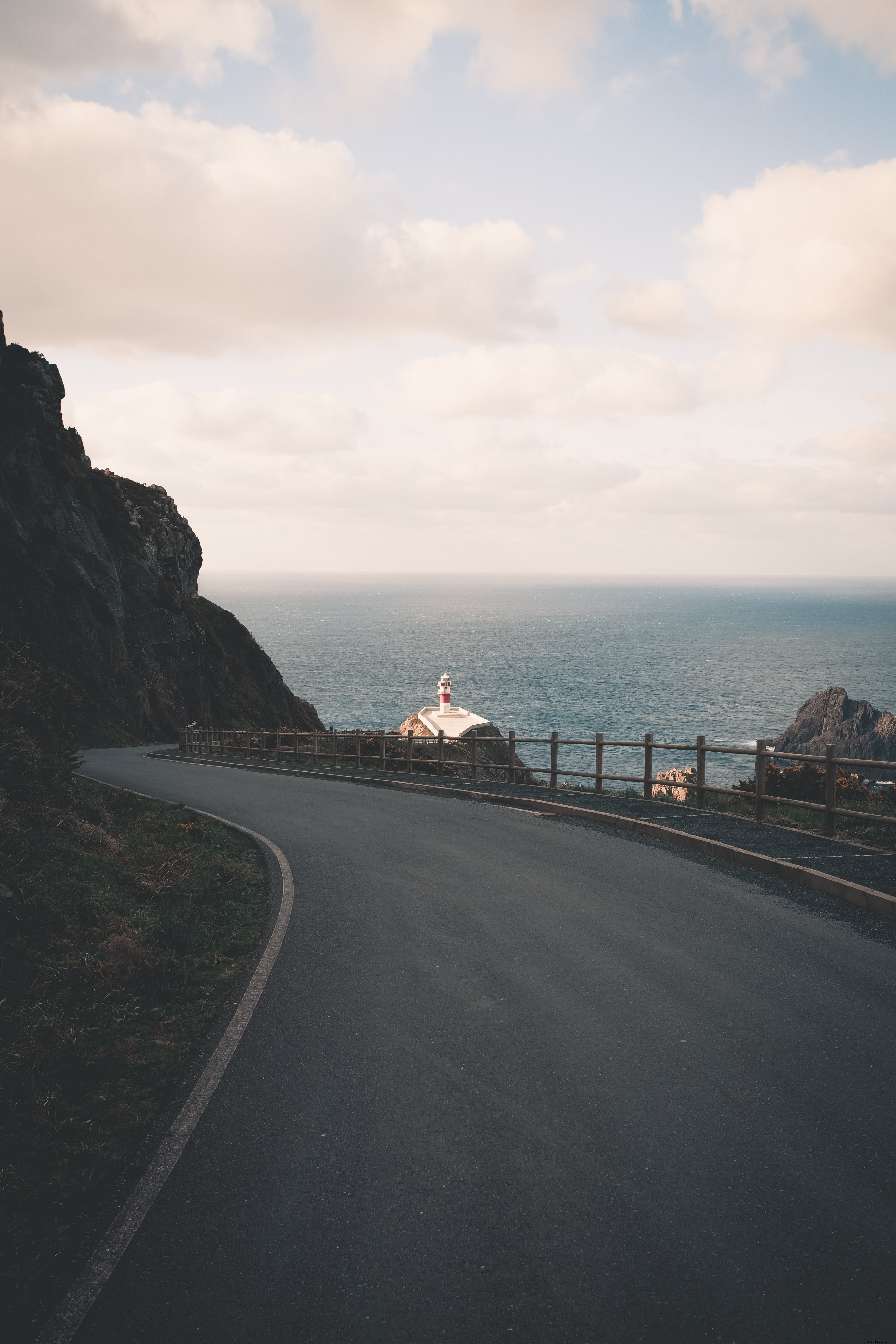 Scenic Winding Road Leading to a Distant Lighthouse – Stunning Photo