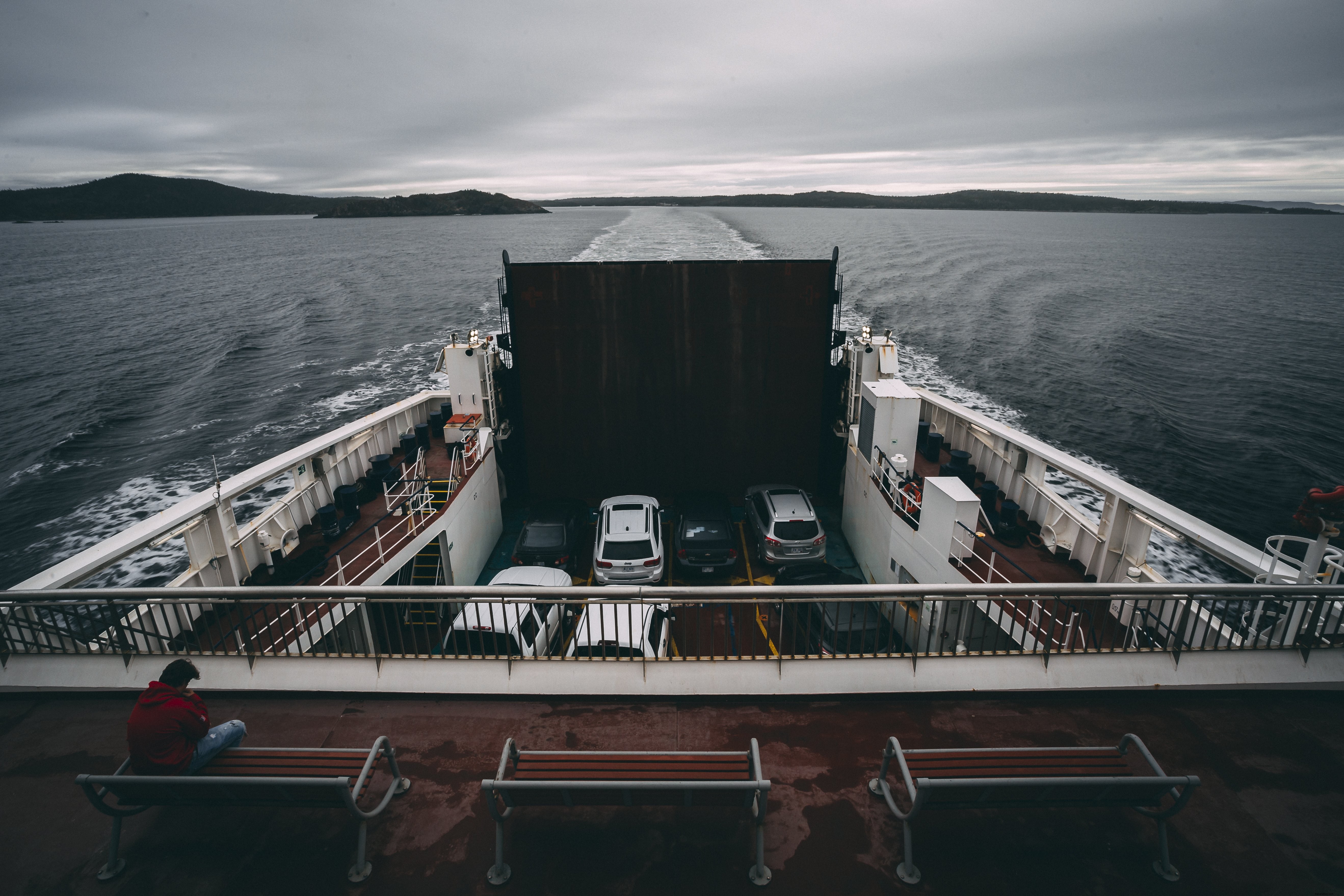 Vivid Photo of Someone Seated on a Ferry Crossing Water