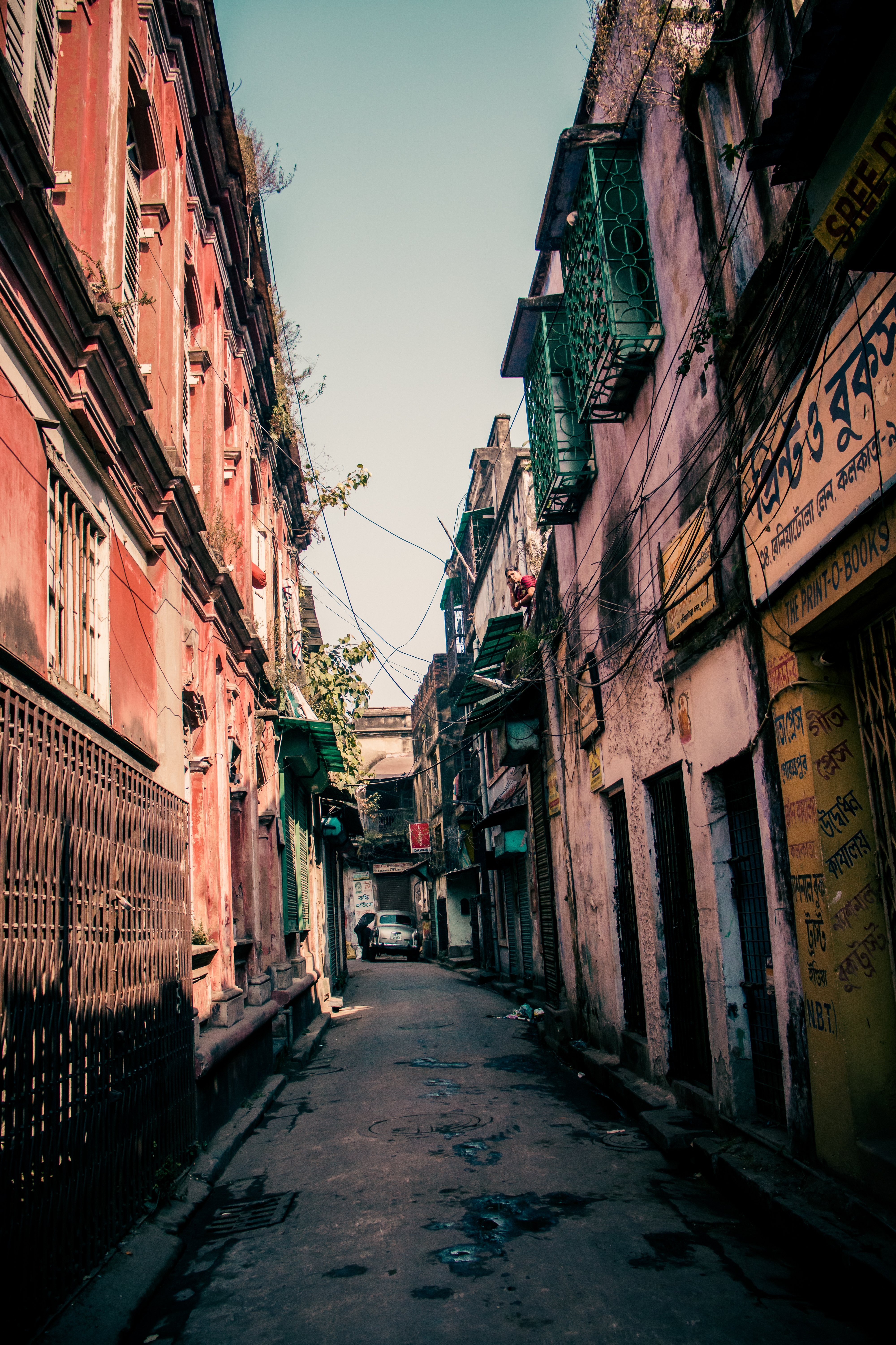 Photo: Narrow Rustic Alleyway Flanked by Historic Buildings