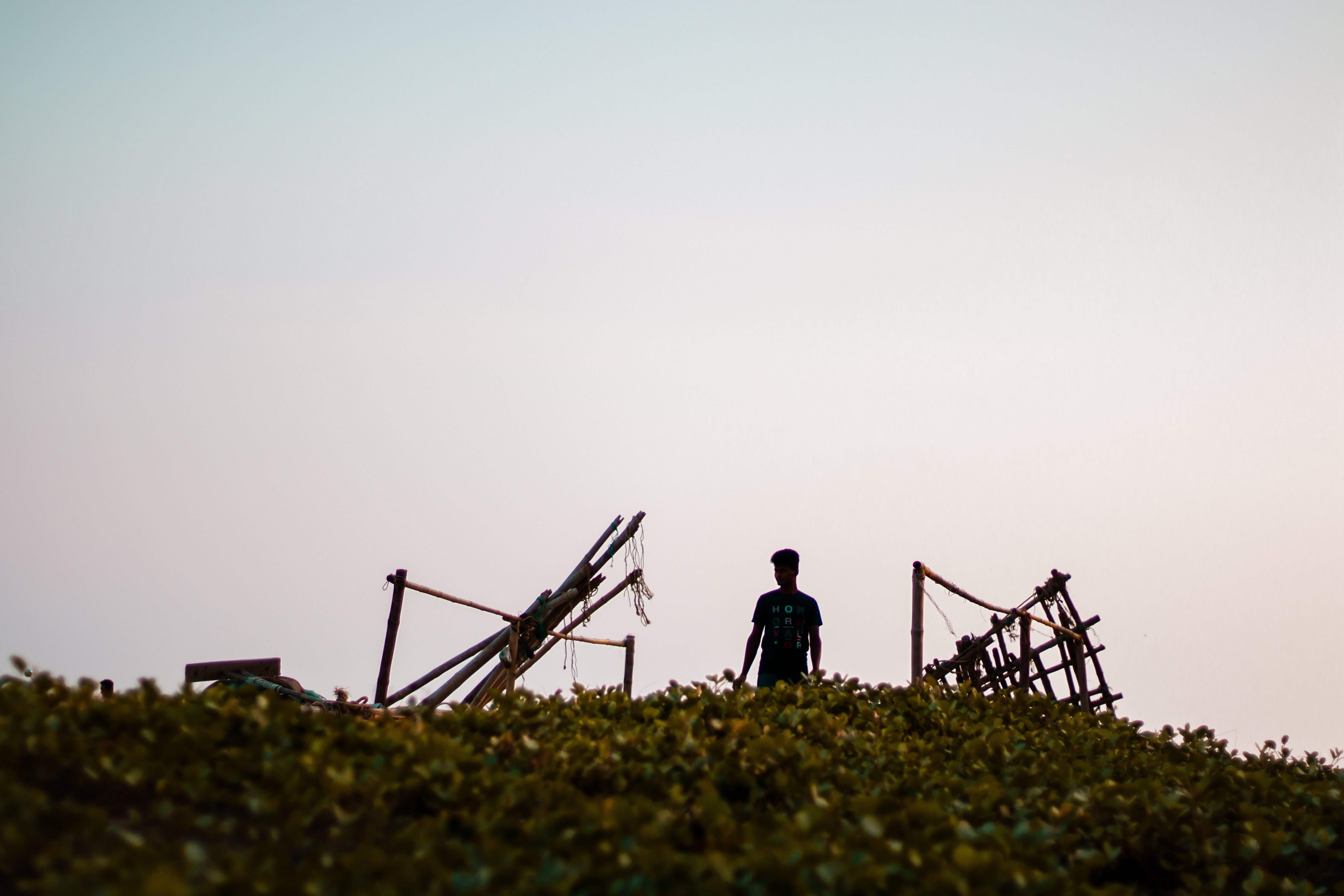 Photo of People Standing Amid Wooden Structure Pieces
