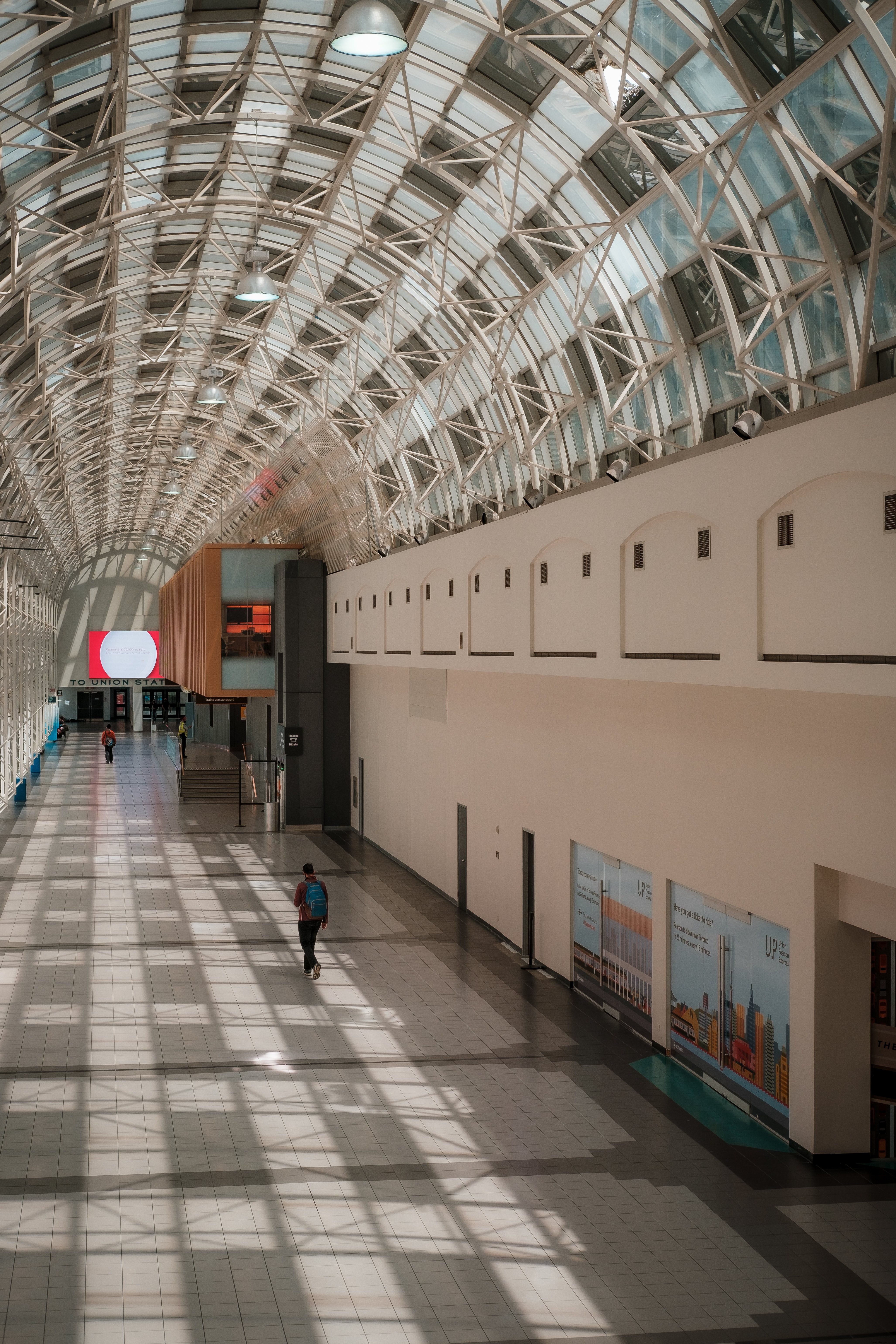 Strolling Through a Grand Atrium with a Curved Ceiling – Captivating Photo