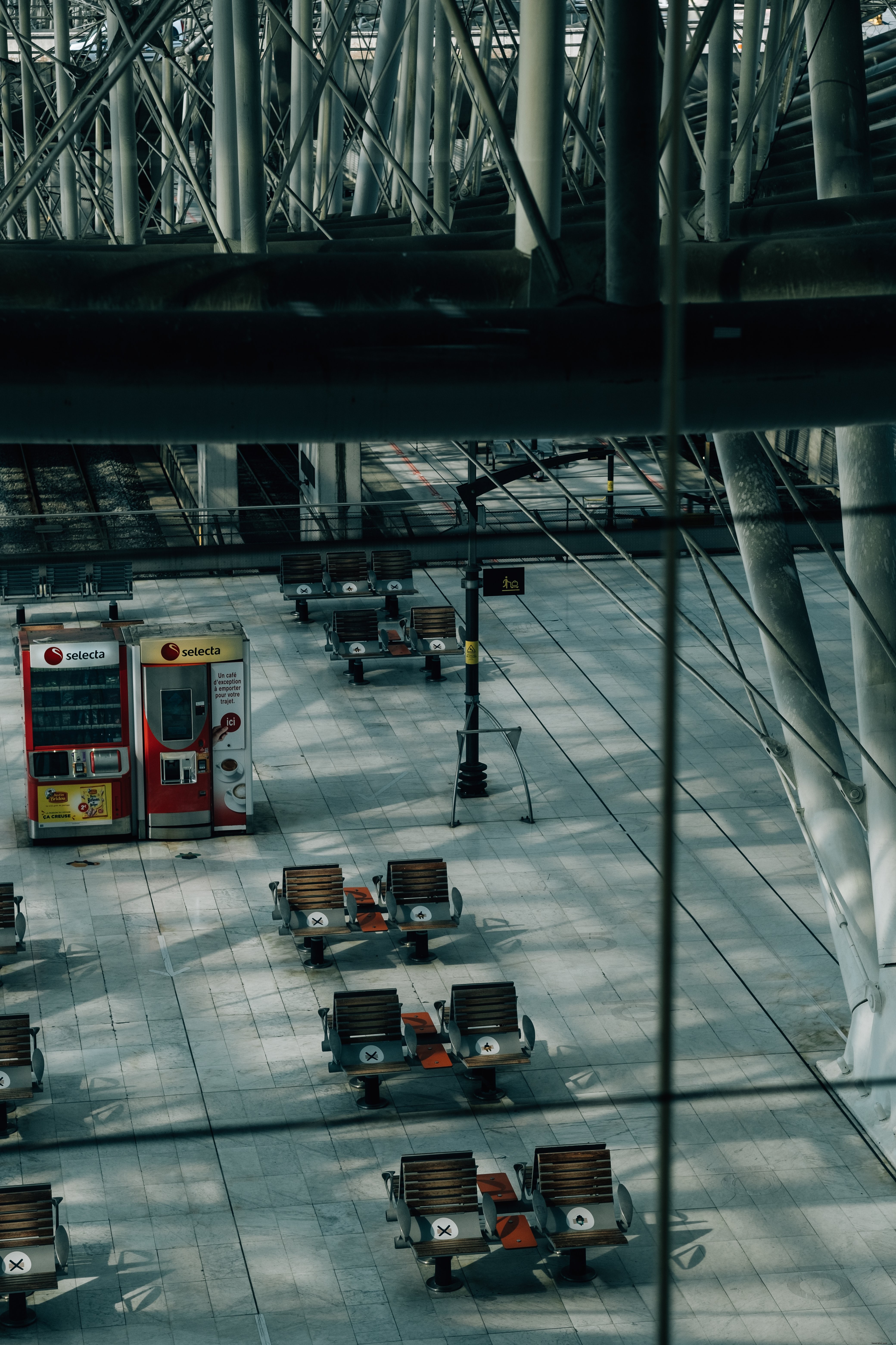 Empty Train Station: Chairs Signify Restricted Areas – Photo