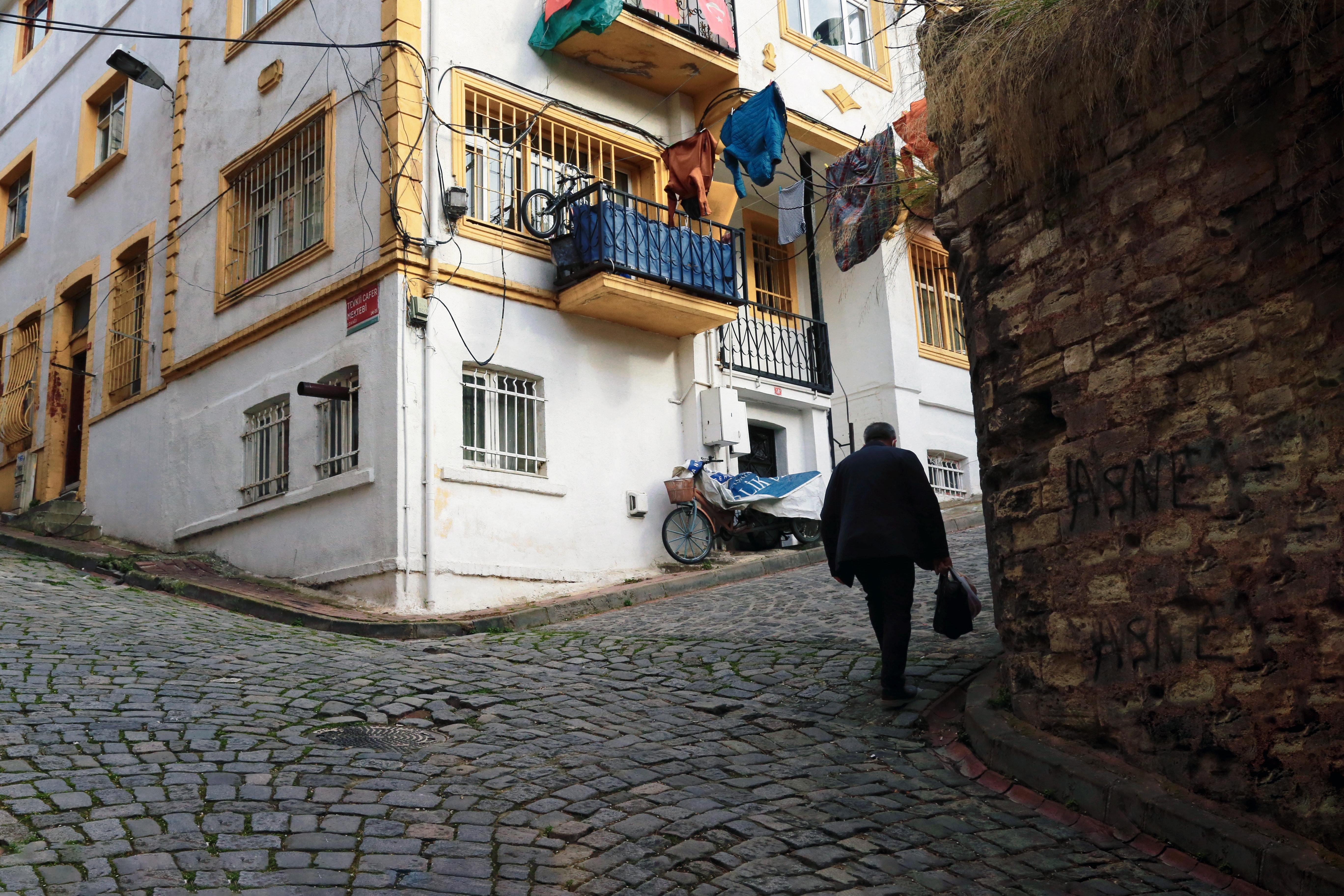 Stroll Through Historic Cobblestone Street Adjacent to White & Yellow Building