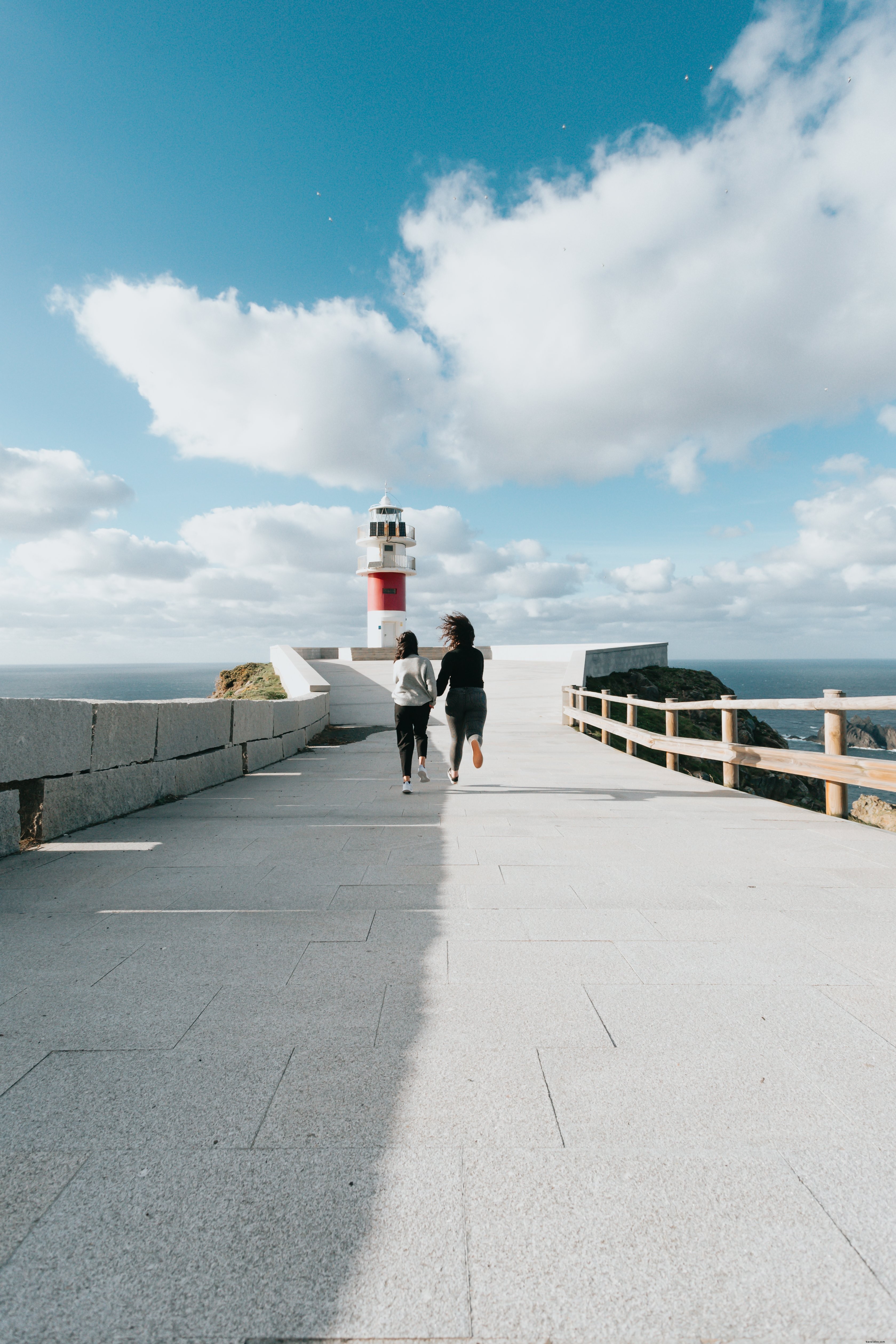 Red and White Lighthouse: Two People Heading Toward the Light