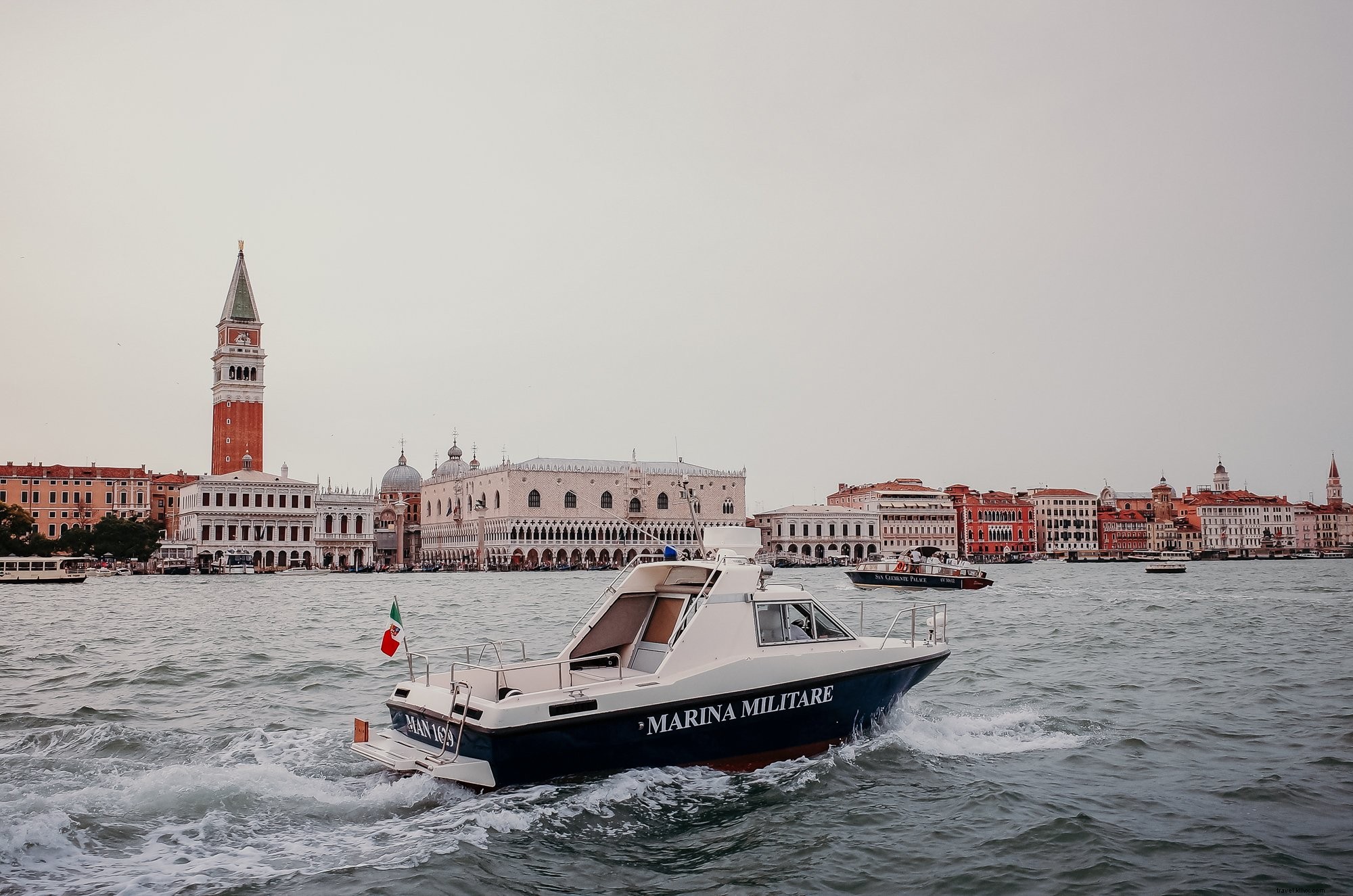 Sailing Serenity: A Boat Navigating Wavy Waters with Distant Cityscape