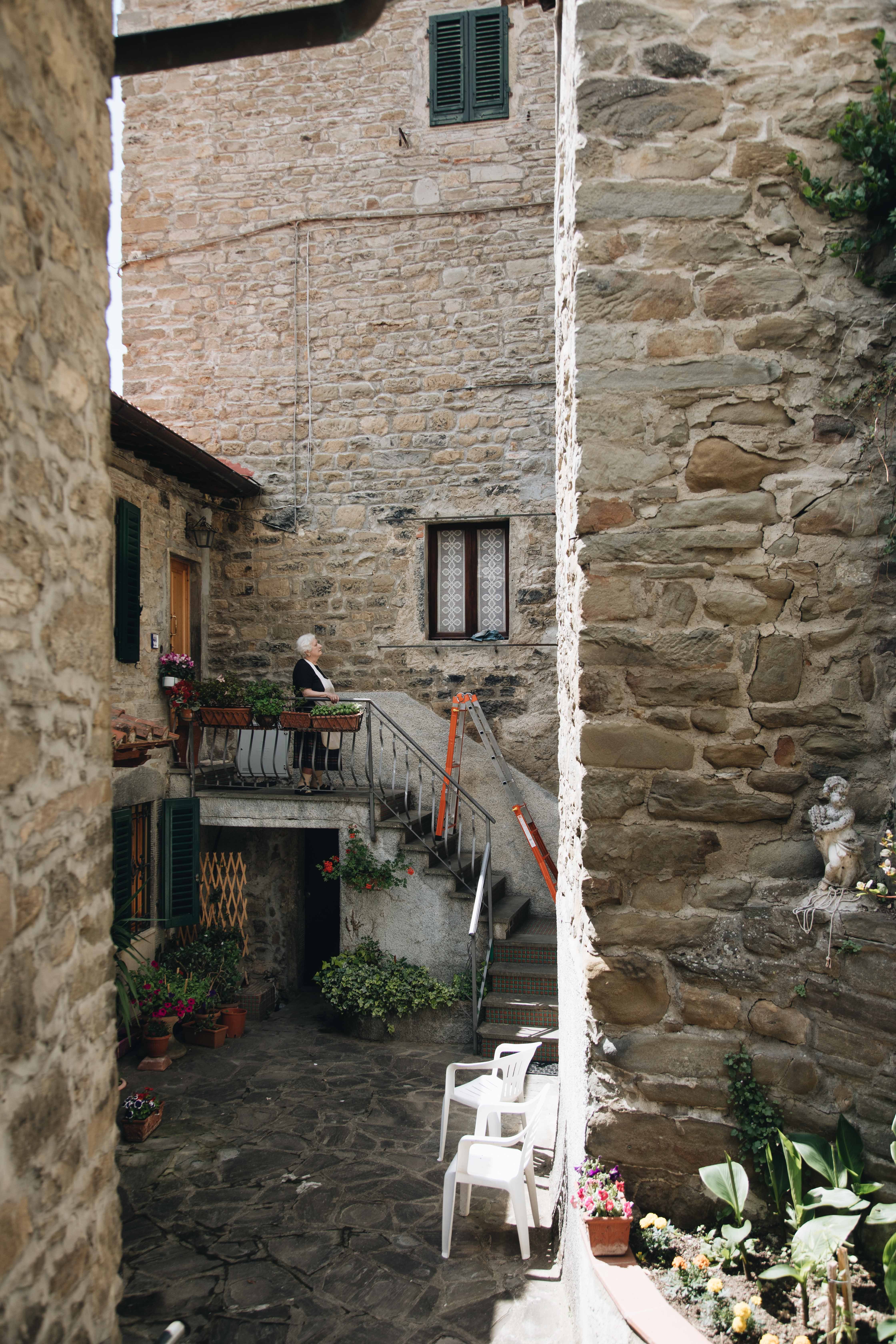 Woman Stands Gracefully on Her Home’s Steps