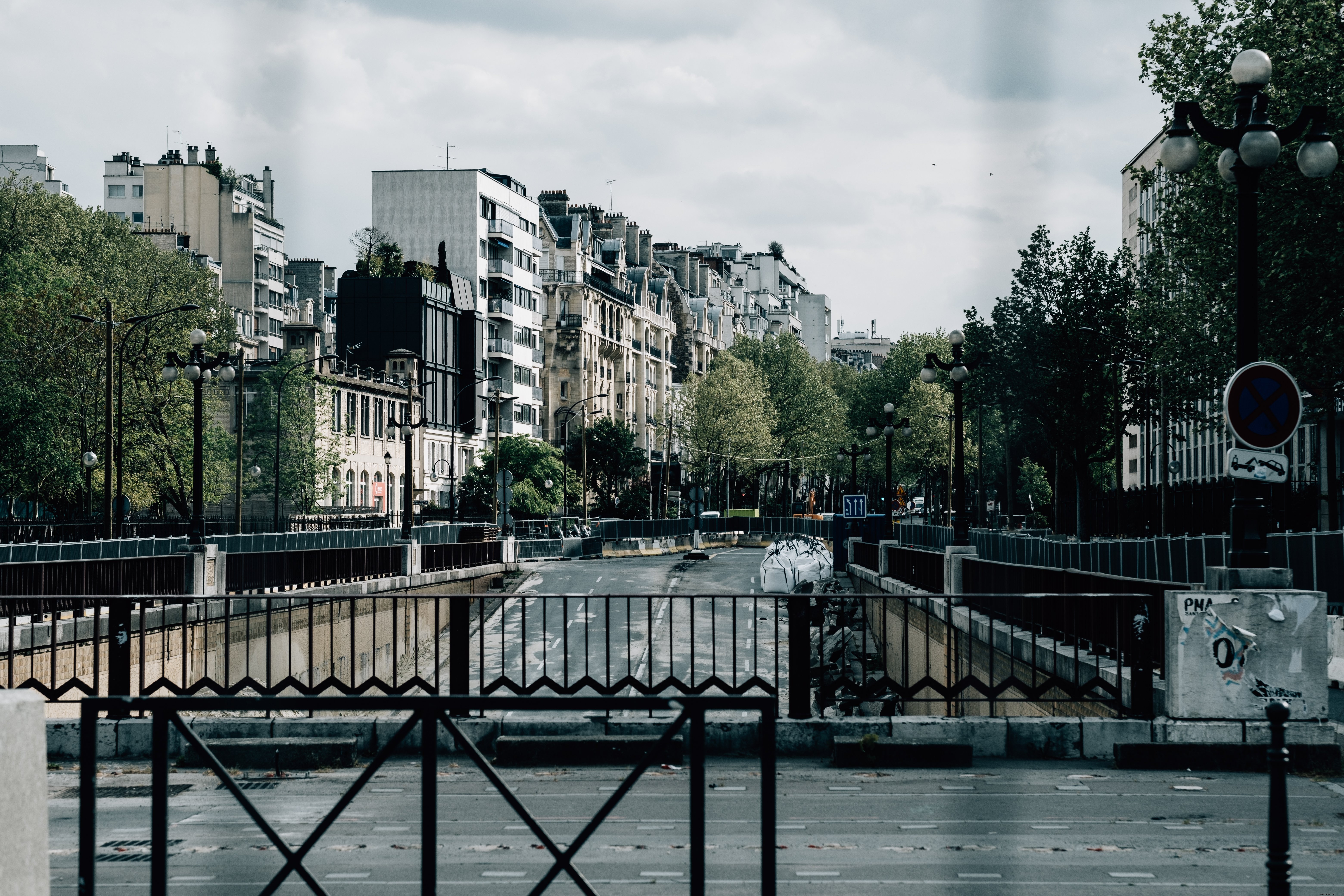 Stunning Urban Landscape: City Street with Lush Trees Captured from a Bridge