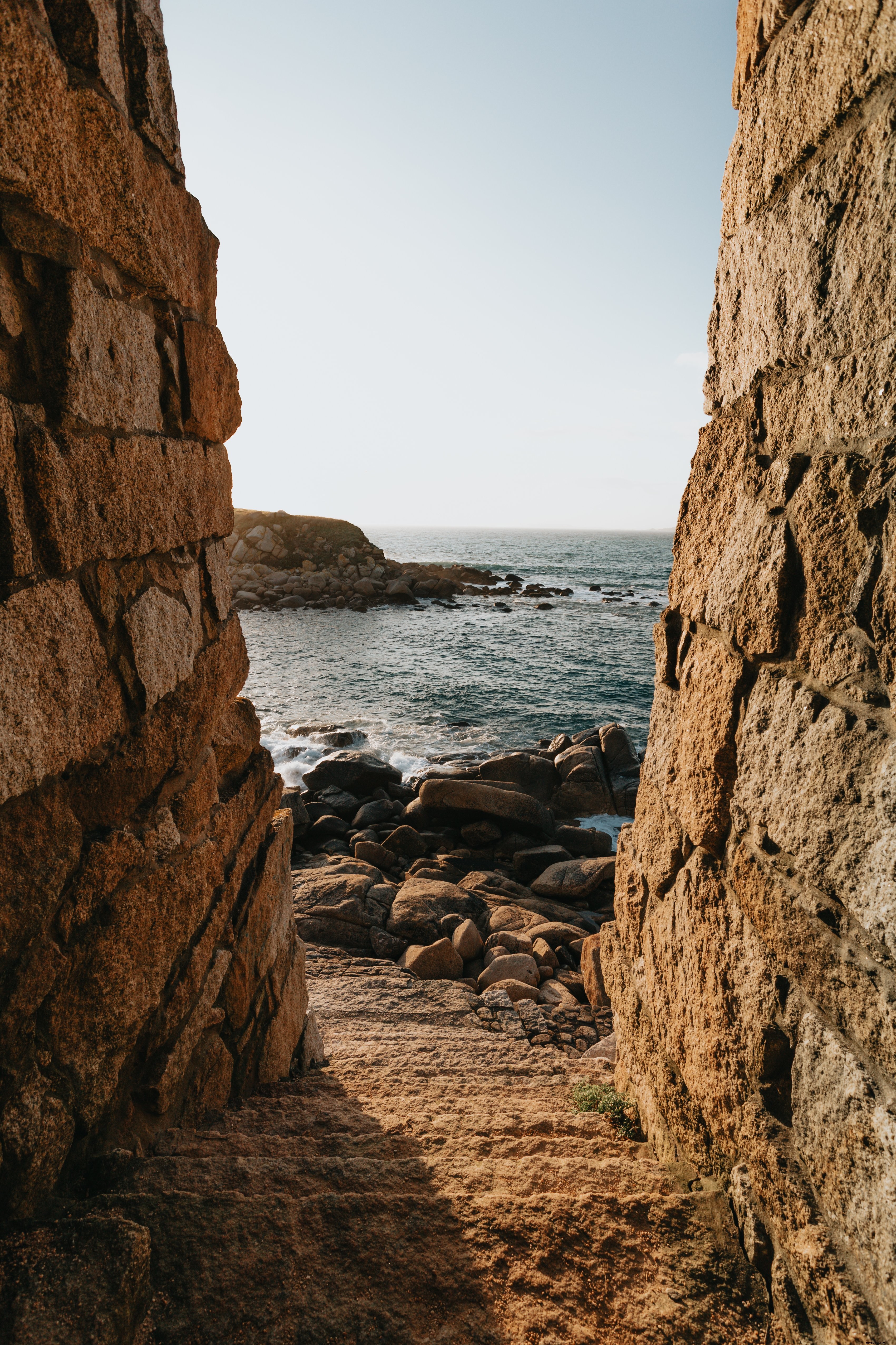 Stone Stairs Leading to a Stone‑Covered Shore – A Captivating Waves Photo