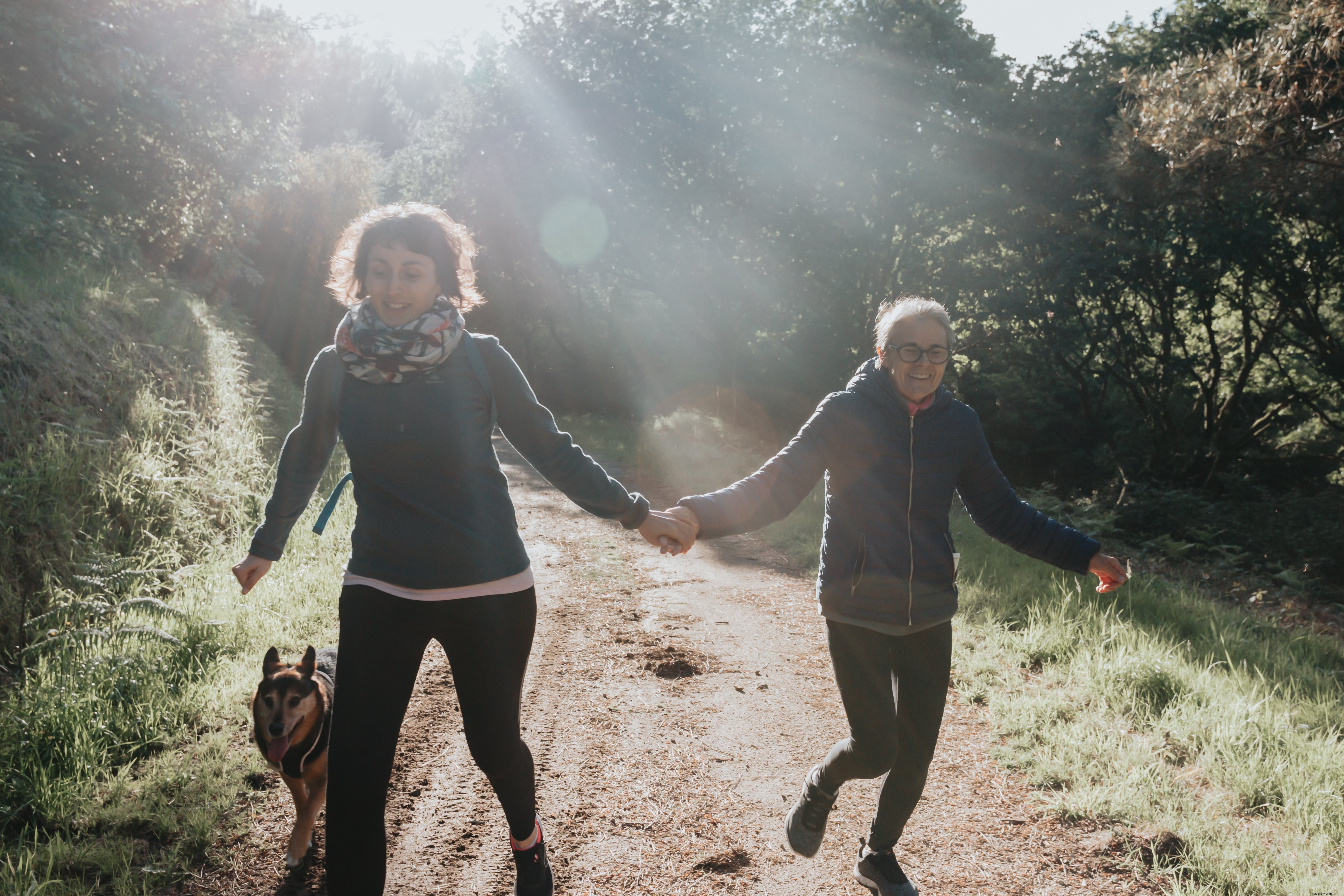 Graceful Moment: Women Walk Hand-in-Hand Along a Path