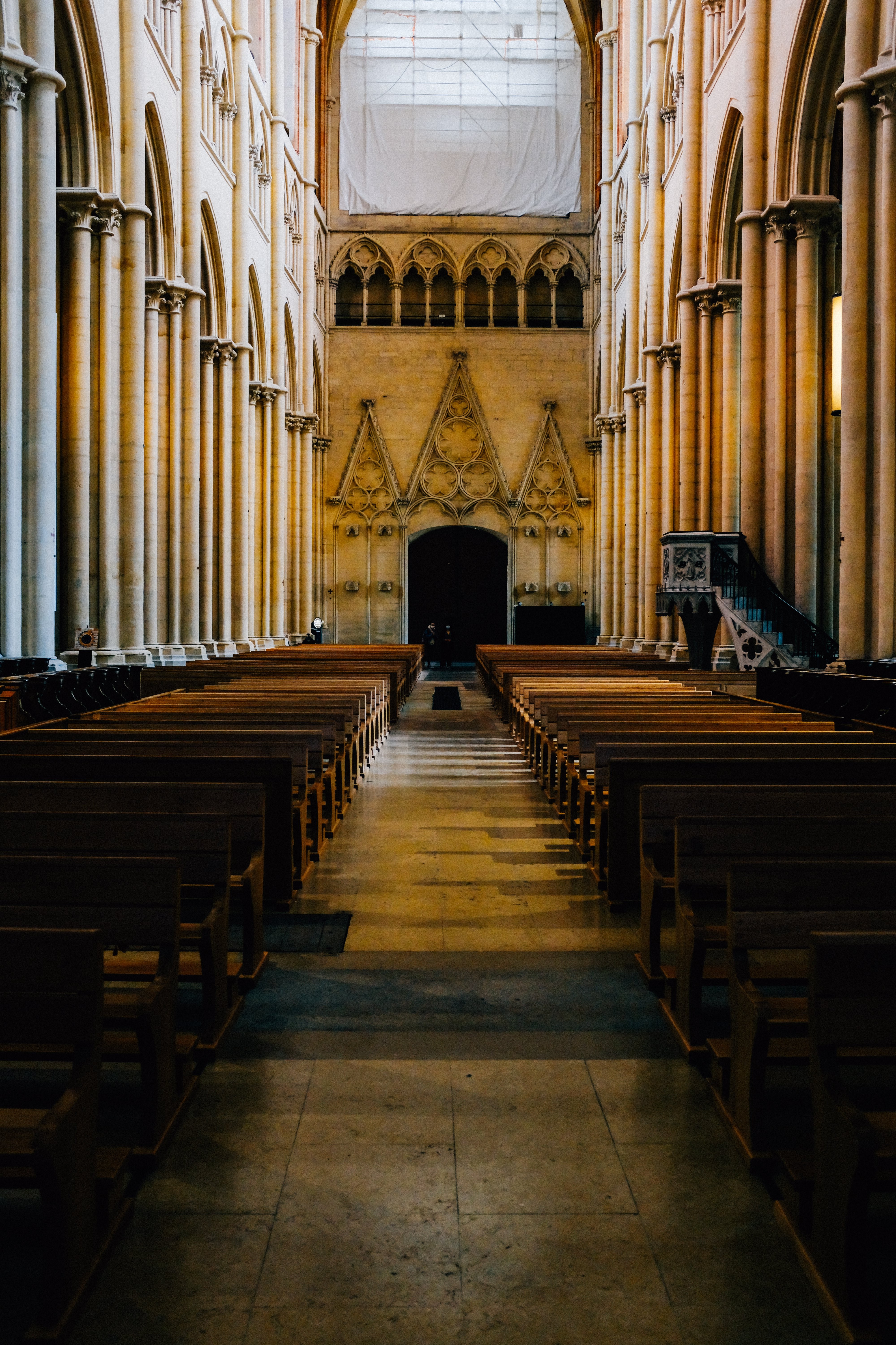 Stunning View: Church Pews Line an Aisle Leading to a Doorway at the End