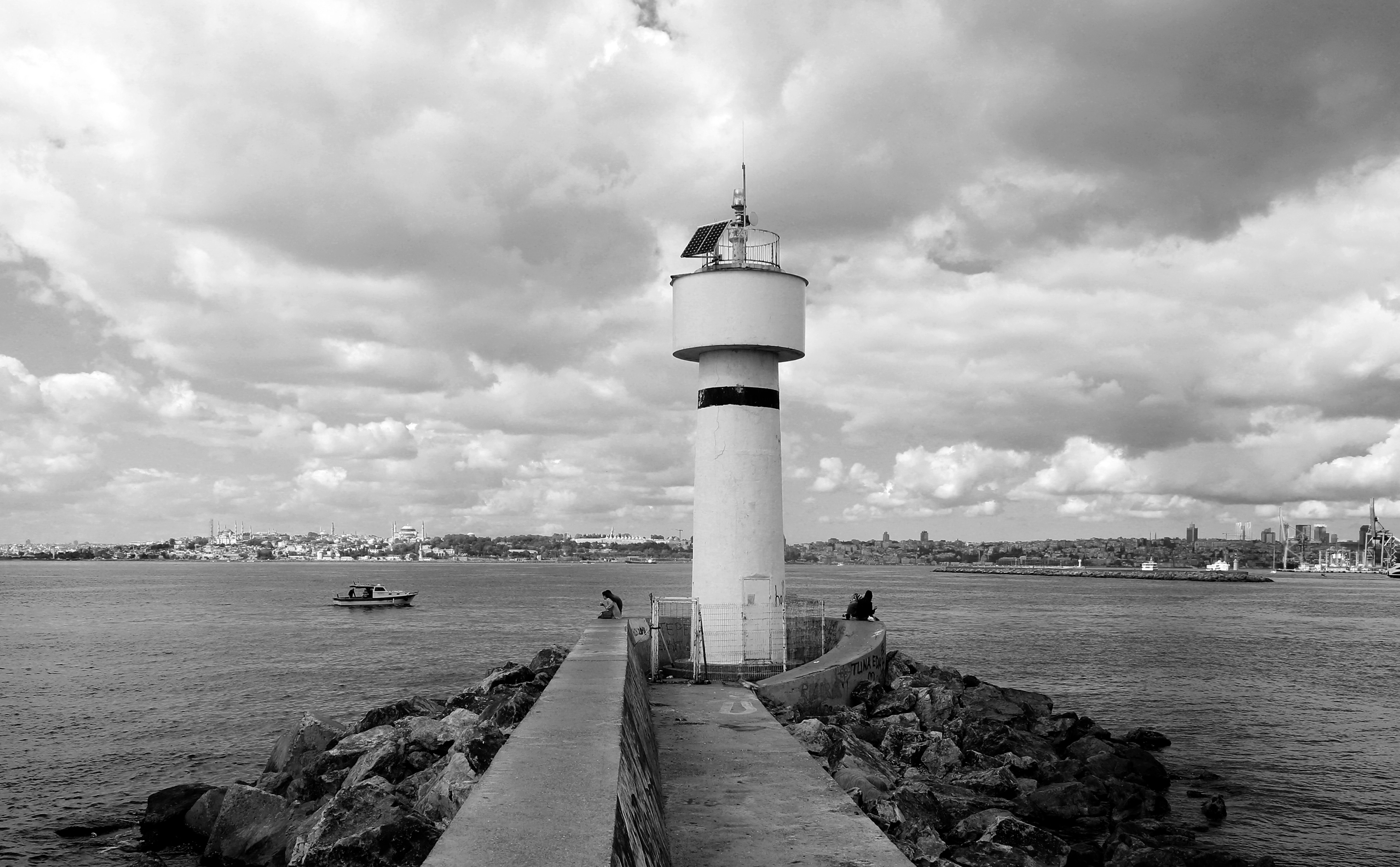Stunning Black‑and‑White Lighthouse Surrounded by Serene Waters