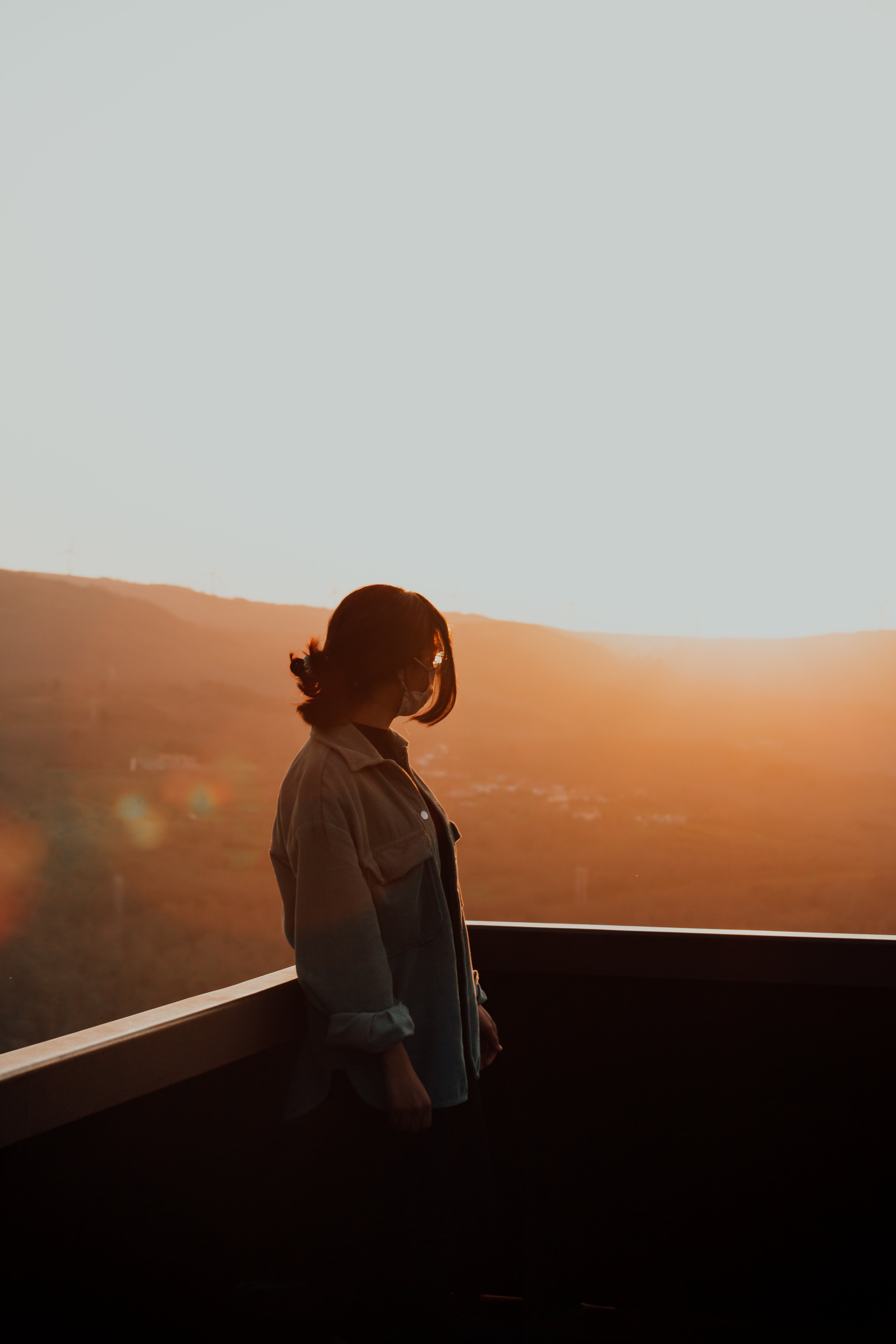 Captivating Sunset Silhouette: A Person Illuminated by Warm Horizon Light