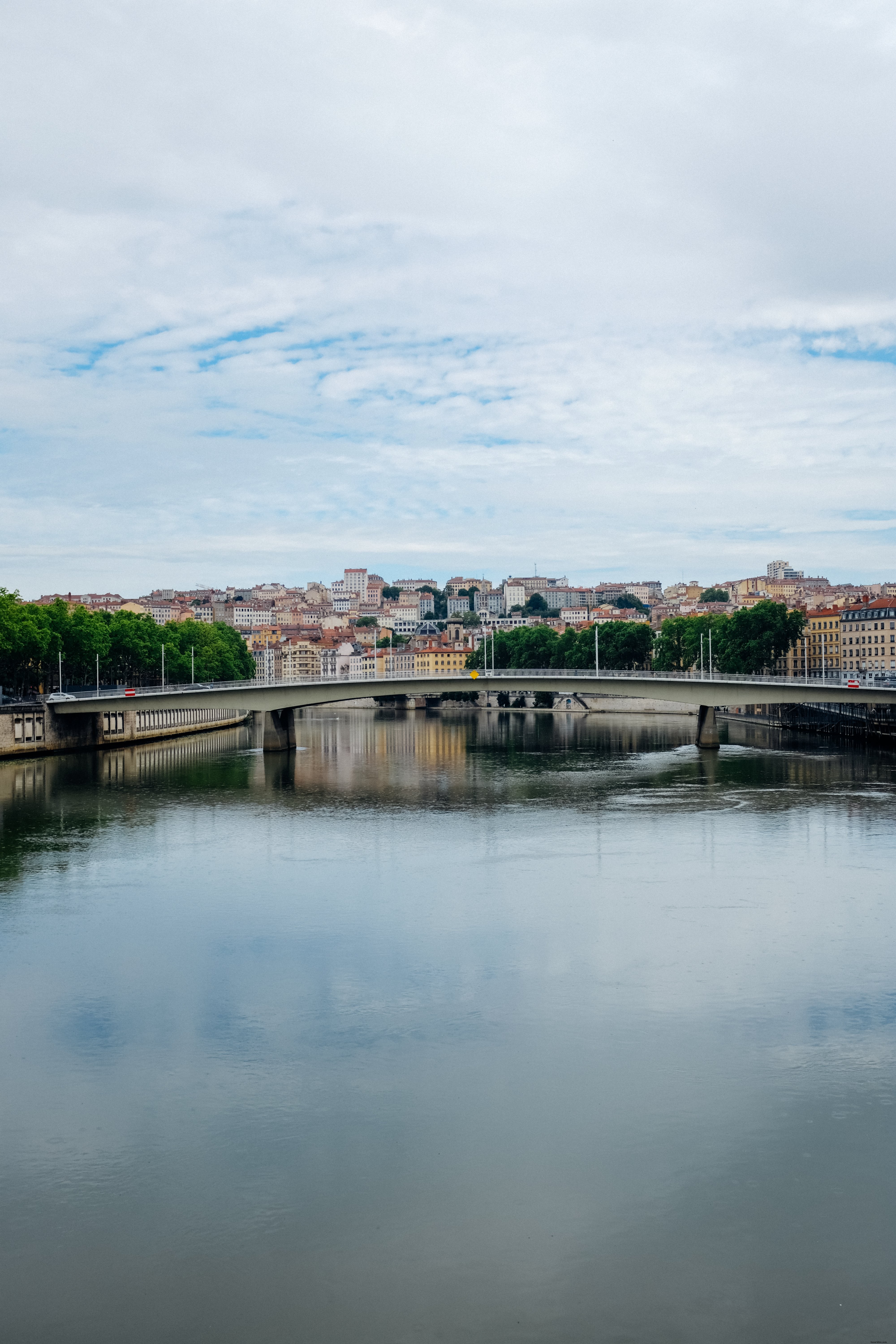 Stunning Panoramic View of a Town and Modern Bridge Reflected in Still Waters