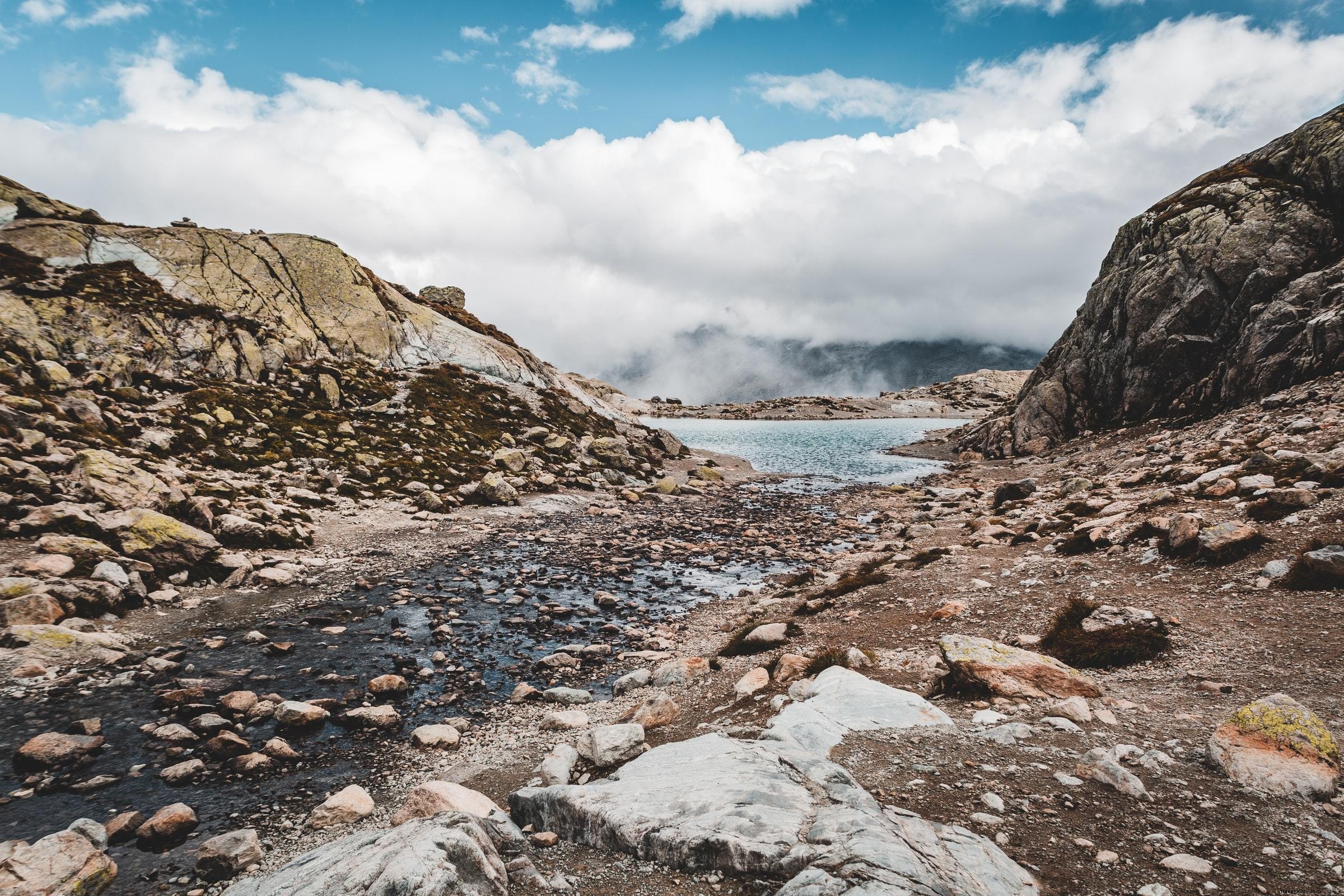Blue Water and Rocky Shore Beneath Low Clouds