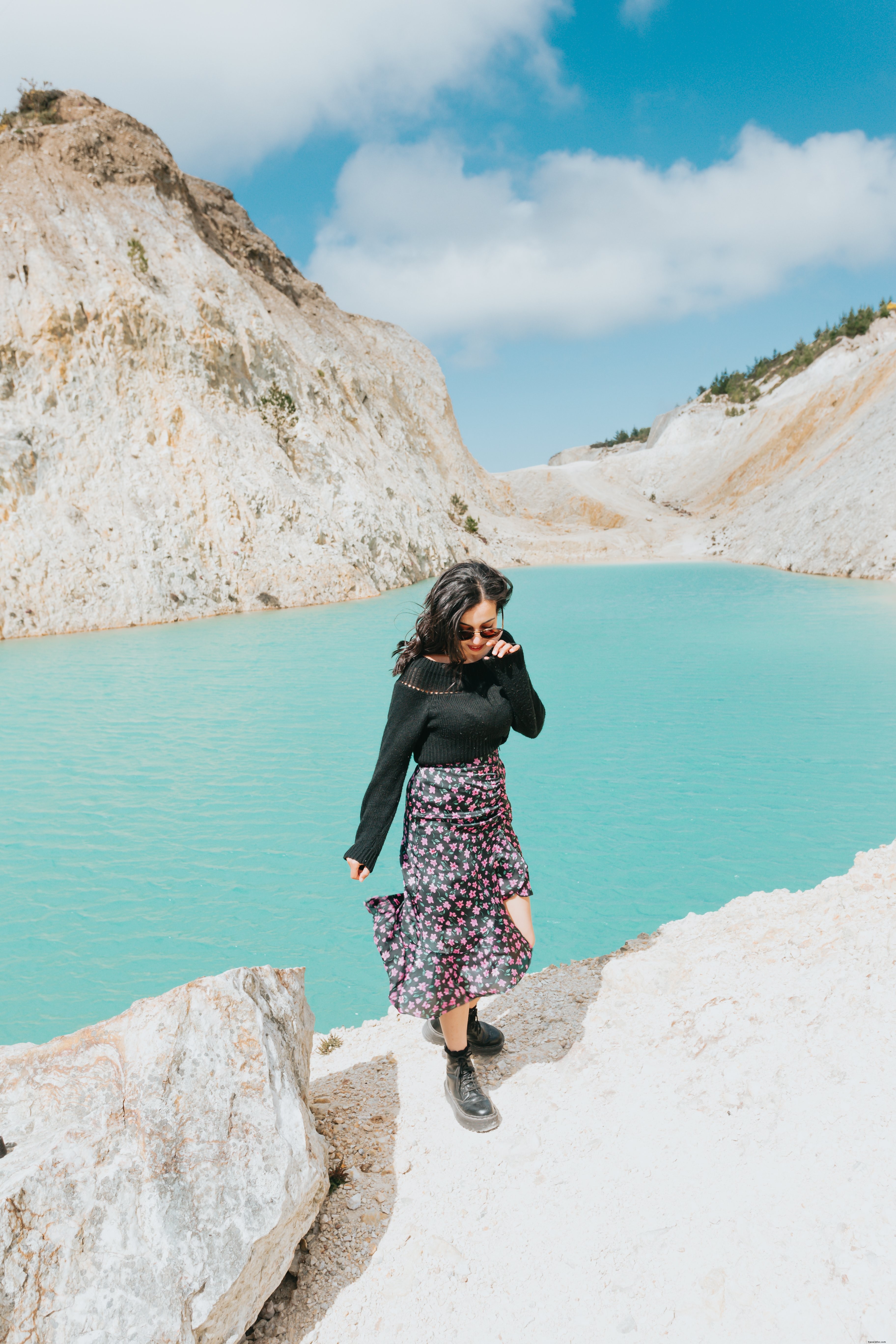 Woman Walking Toward the Camera by a Serene Blue Lake