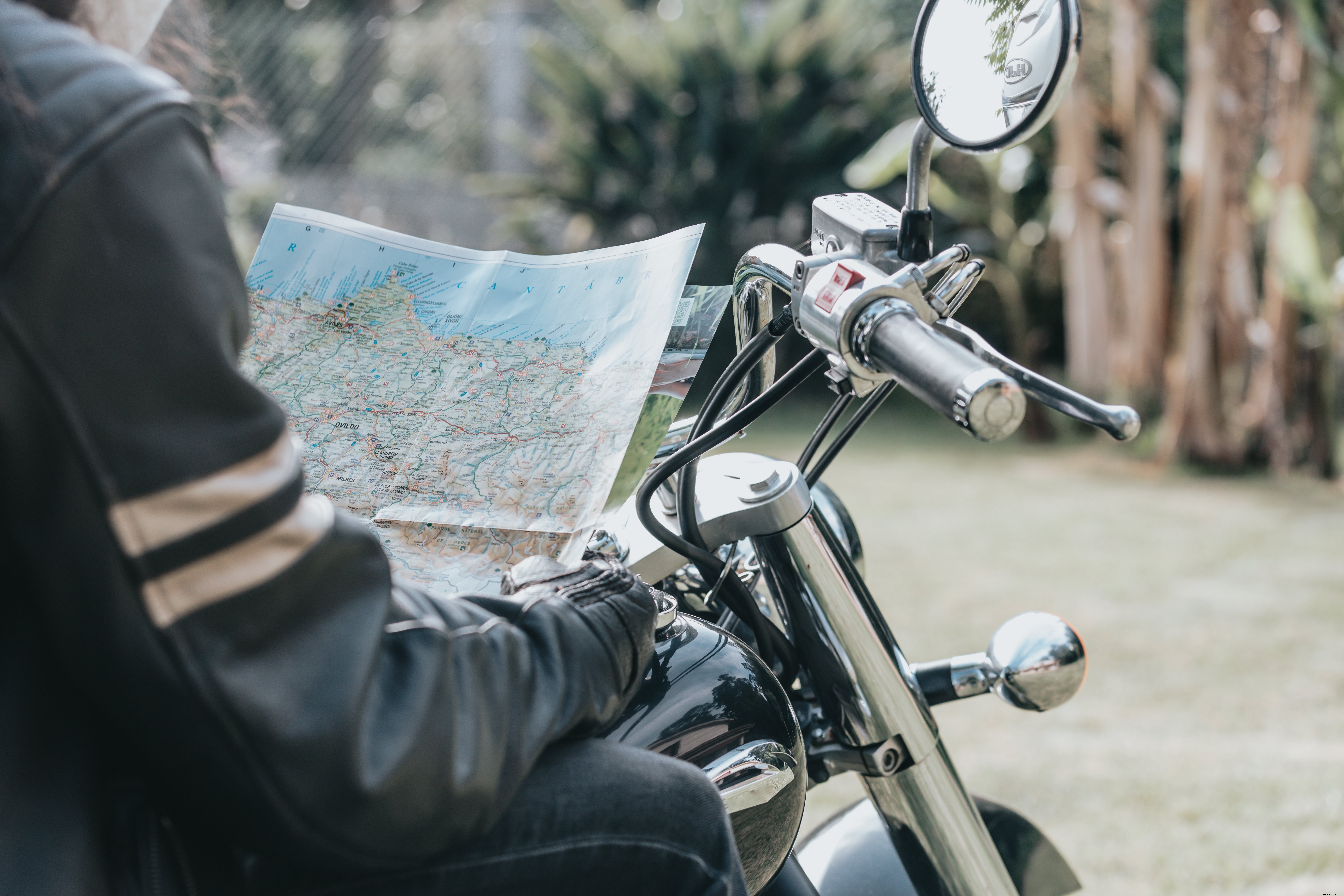 Motorcyclist’s Torso Holding a Map: A Dynamic Photo