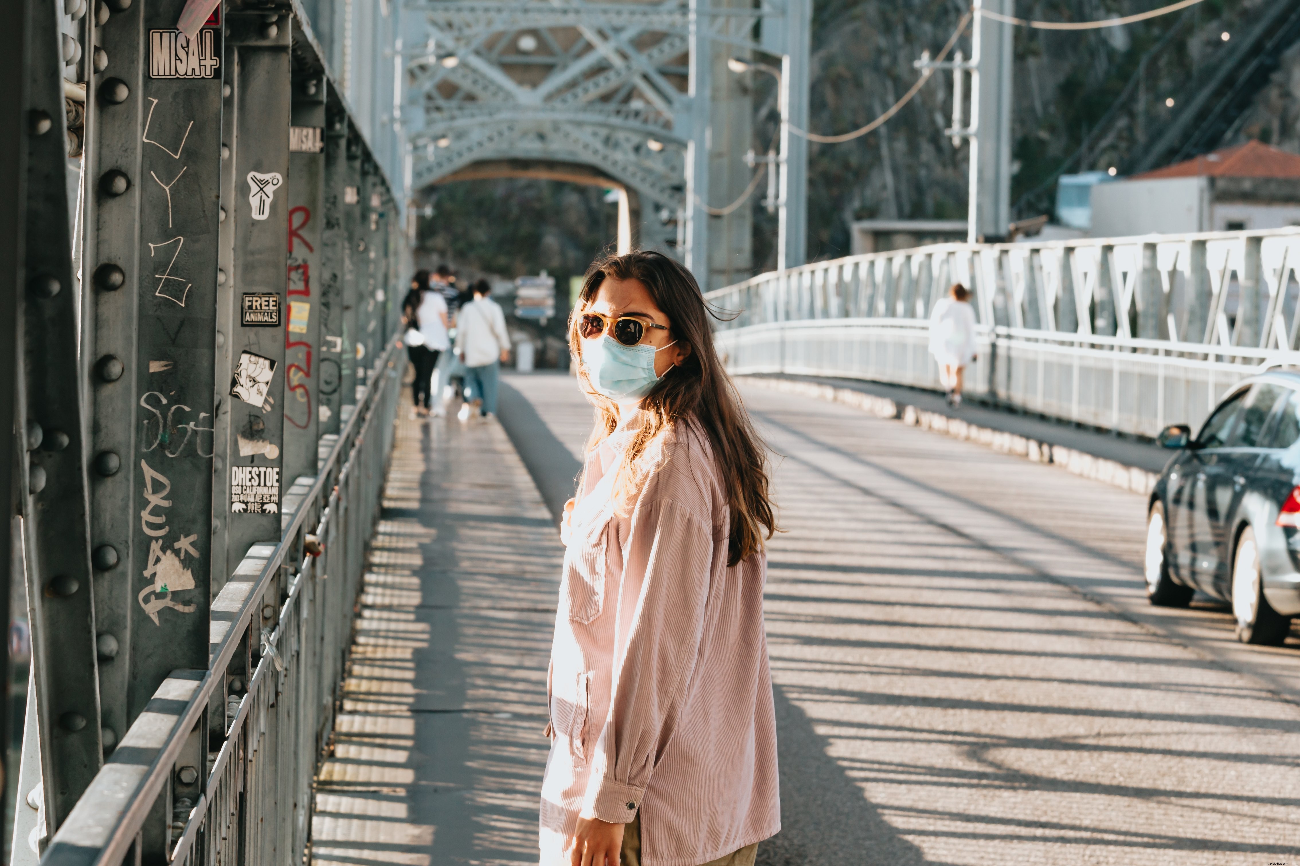 Candid Photo of Woman on Bridge Wearing Face Mask