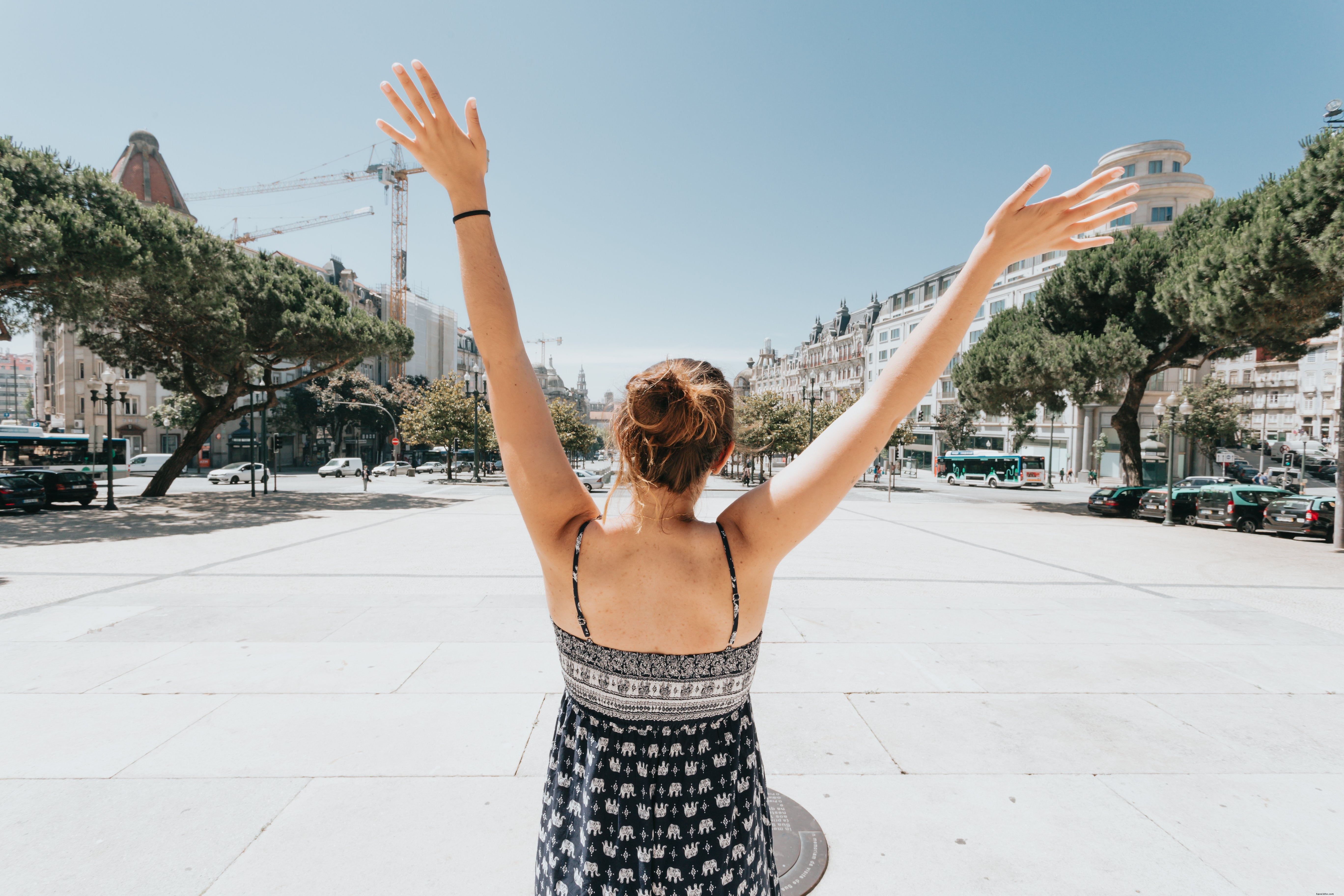 Graceful Portrait: Woman Raising Hands in Courtyard