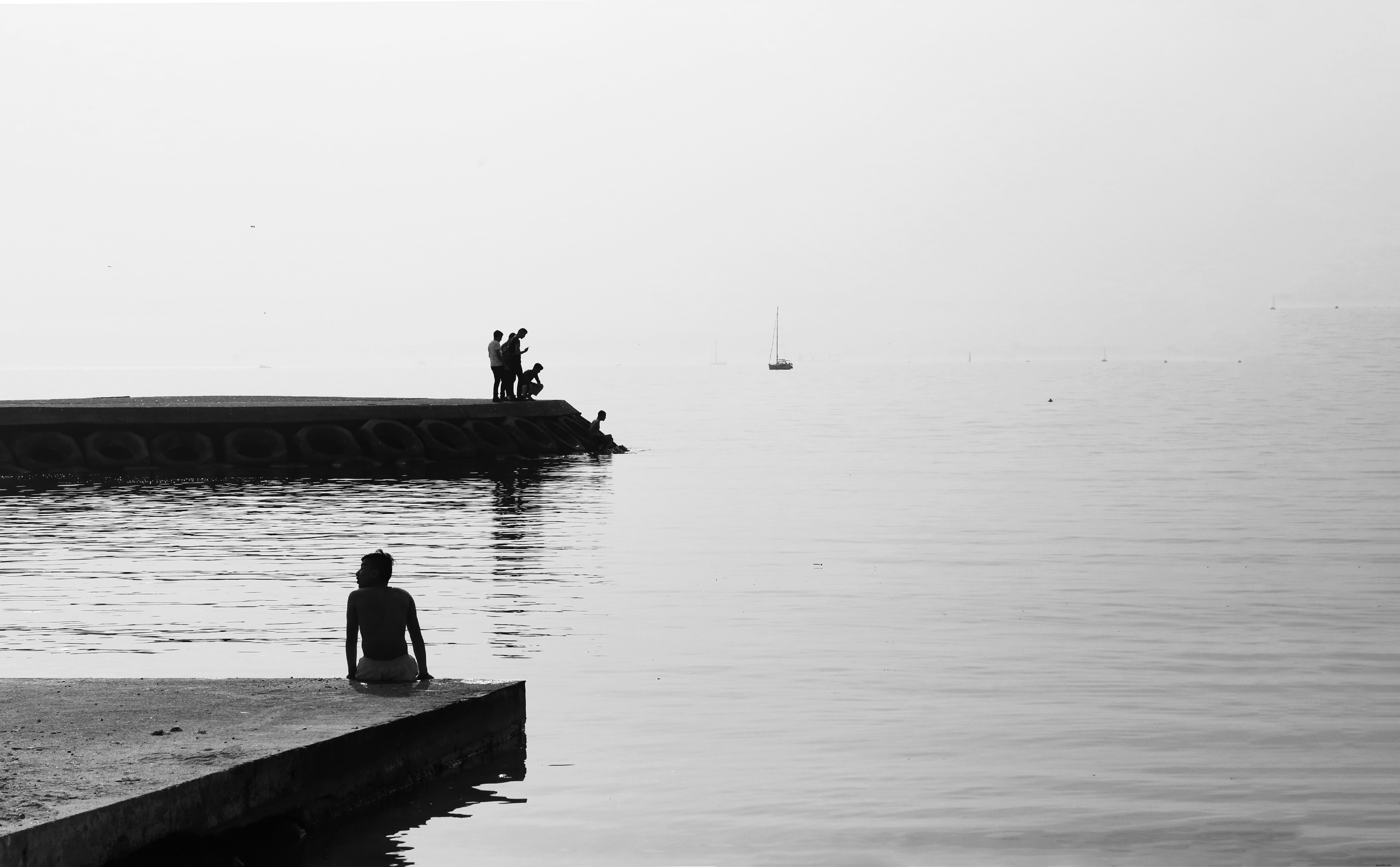 Timeless Black & White Portrait of People on a Concrete Shore by Calm Waters