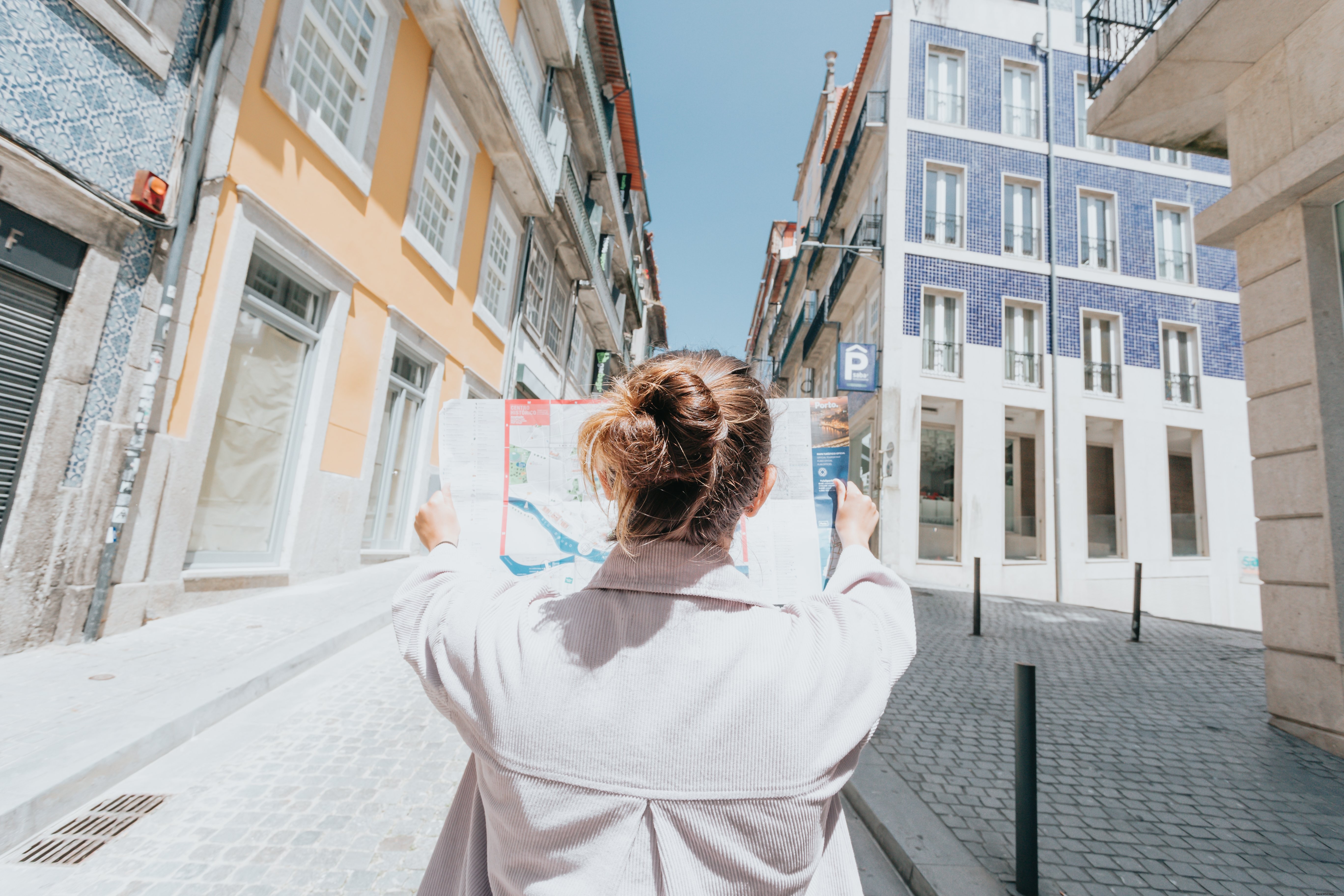 Person Holds Up Map on a City Street – Captured Photo
